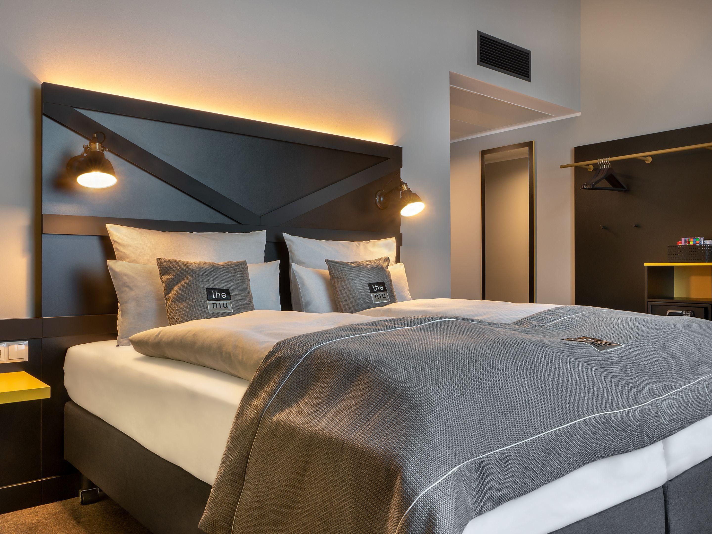 Bright modern standard room with a comfortable queen bed