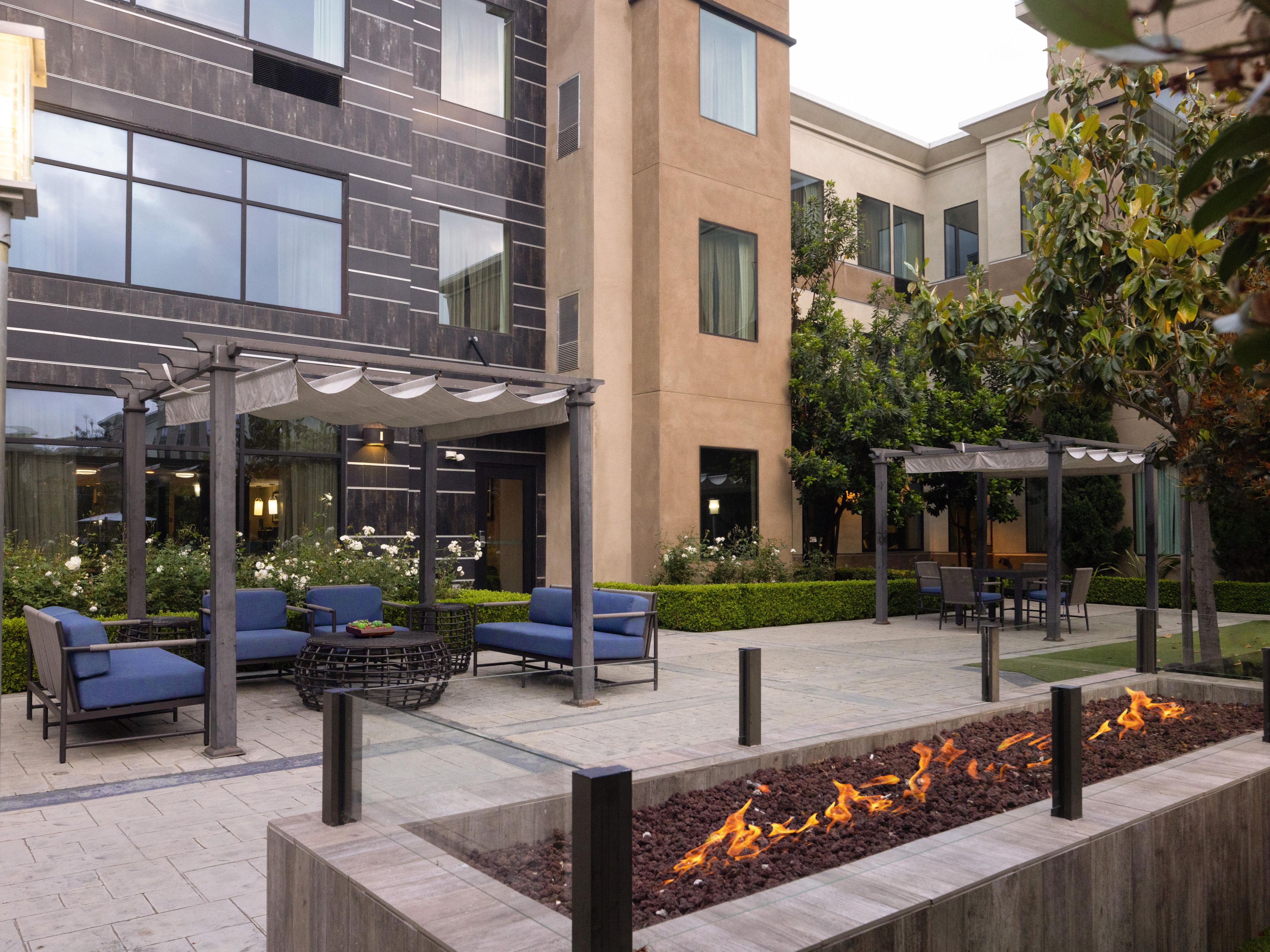 Relax outside with patio seating and a fireplace. 