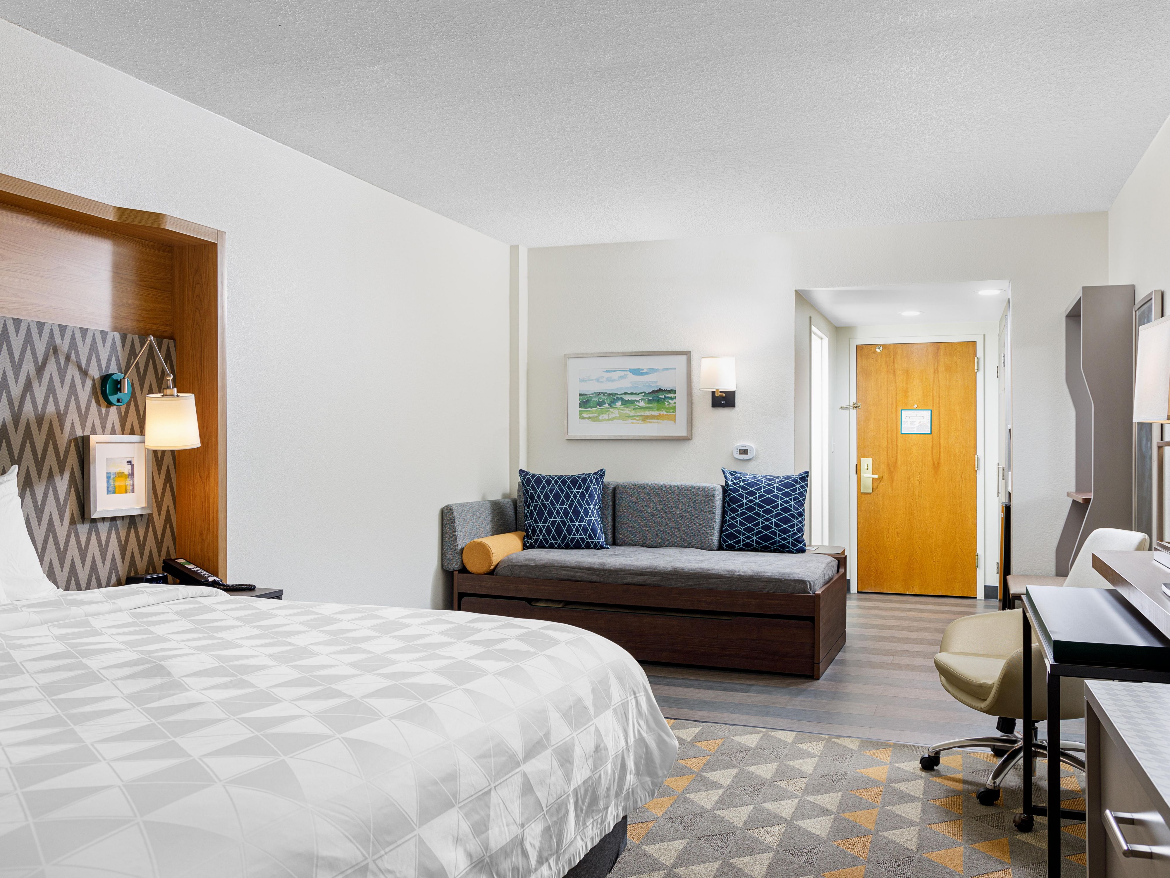 Unwind in spacious rooms designed for comfort and productivity. Enjoy premium bedding and bath amenities, ample workspace, and free Wi-Fi. From a mini fridge and microwave to a coffee maker and free Wi-Fi, we ensure you have everything you need for a relaxing and productive stay.