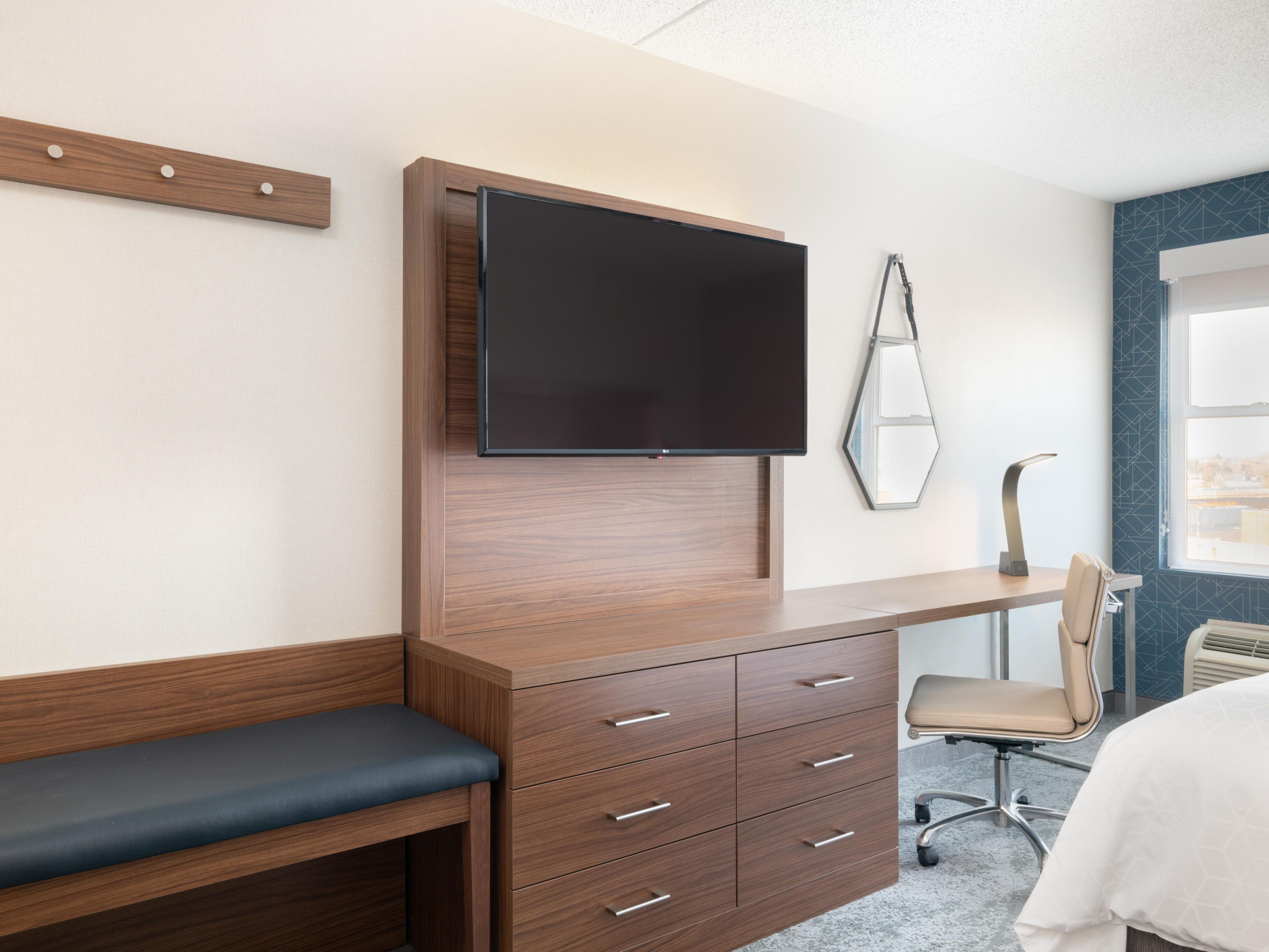 Our standard rooms and suites feature spacious layouts, and select rooms feature living areas with sofa beds and city views. Each room includes a large desk, modern tech features like wireless charging and plenty of outlets, as well as flat-screen TVs, premium brand coffee makers, microwaves, mini-fridges, blackout shades and a laptop safe.