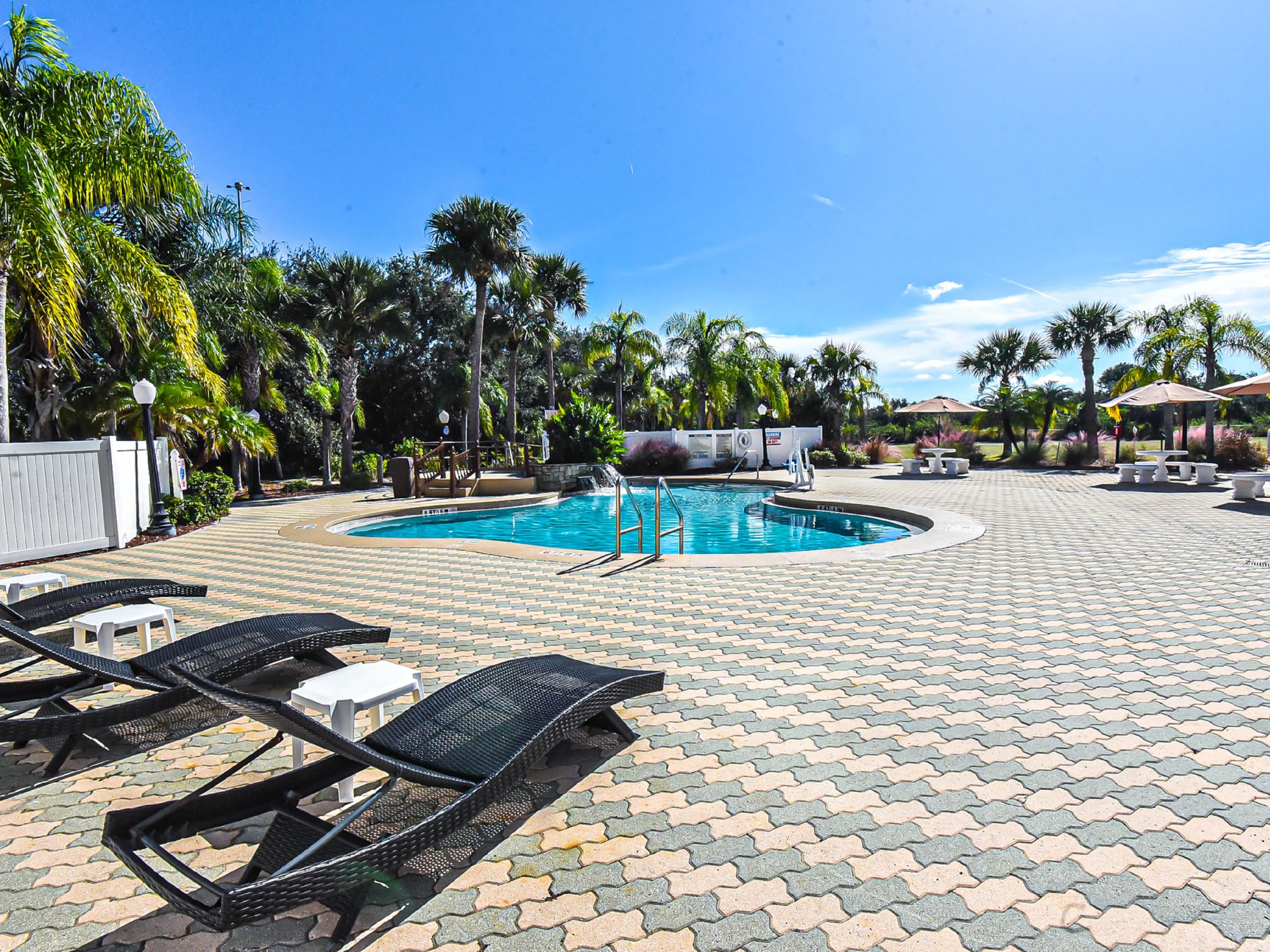 Our spacious pool area features lounge chairs and a waterfall.