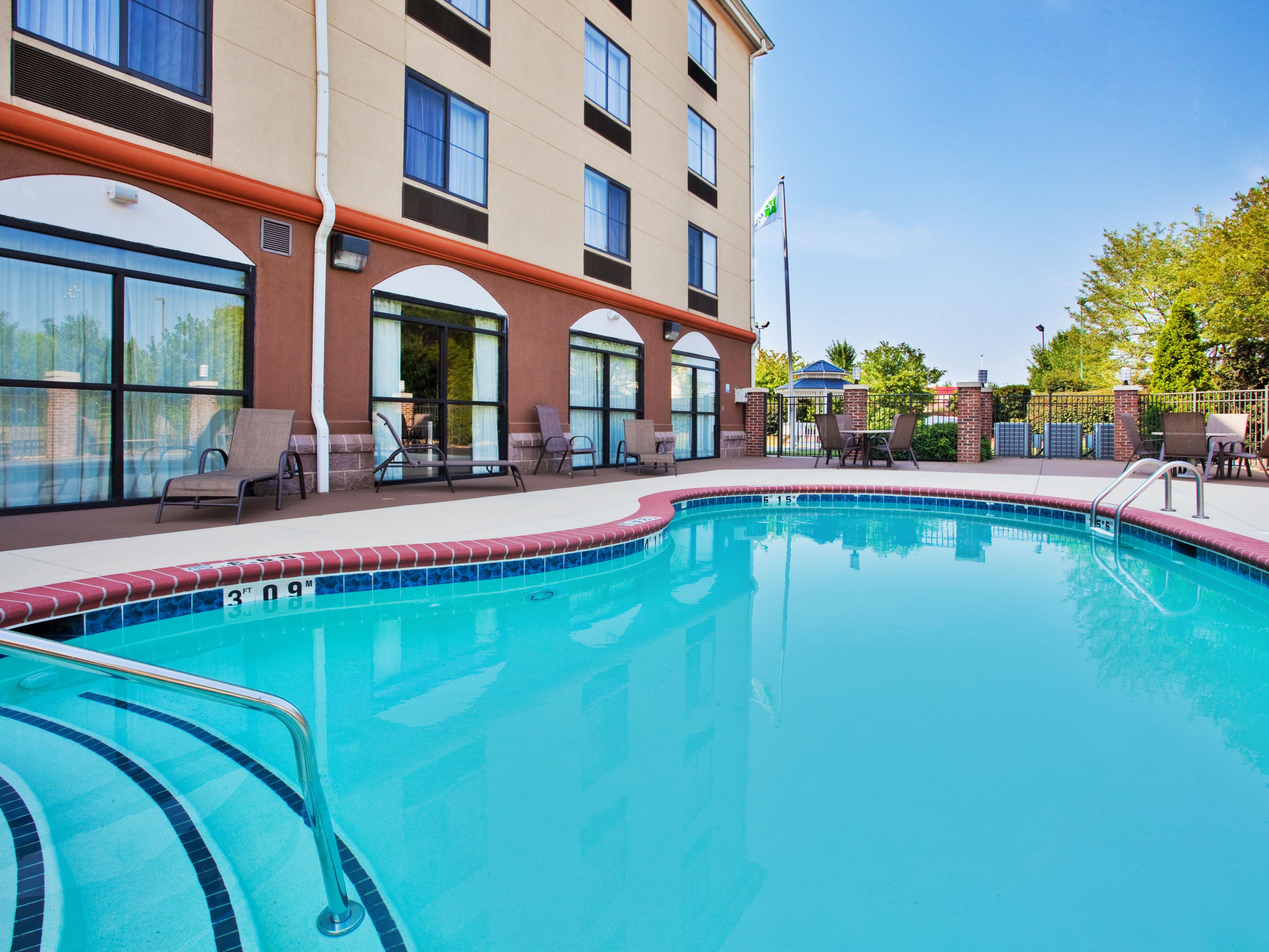 Dive into relaxation in our outdoor pool under sunny skies.