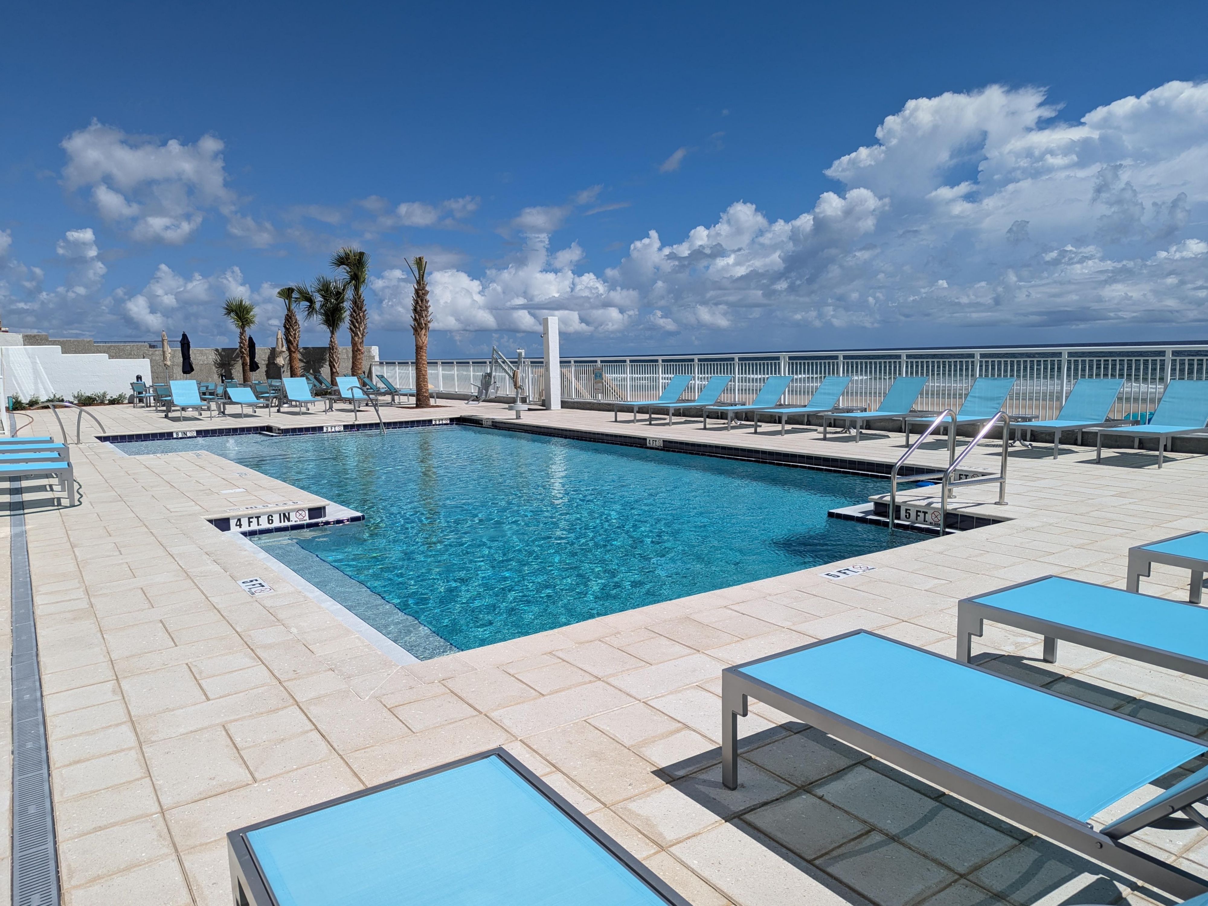Nestled along the coastline, this expansive pool offers a stunning vantage point of the Atlantic Ocean. This pool features a classic design with clear, inviting waters framed by elegant tilework and comfortable loungers.