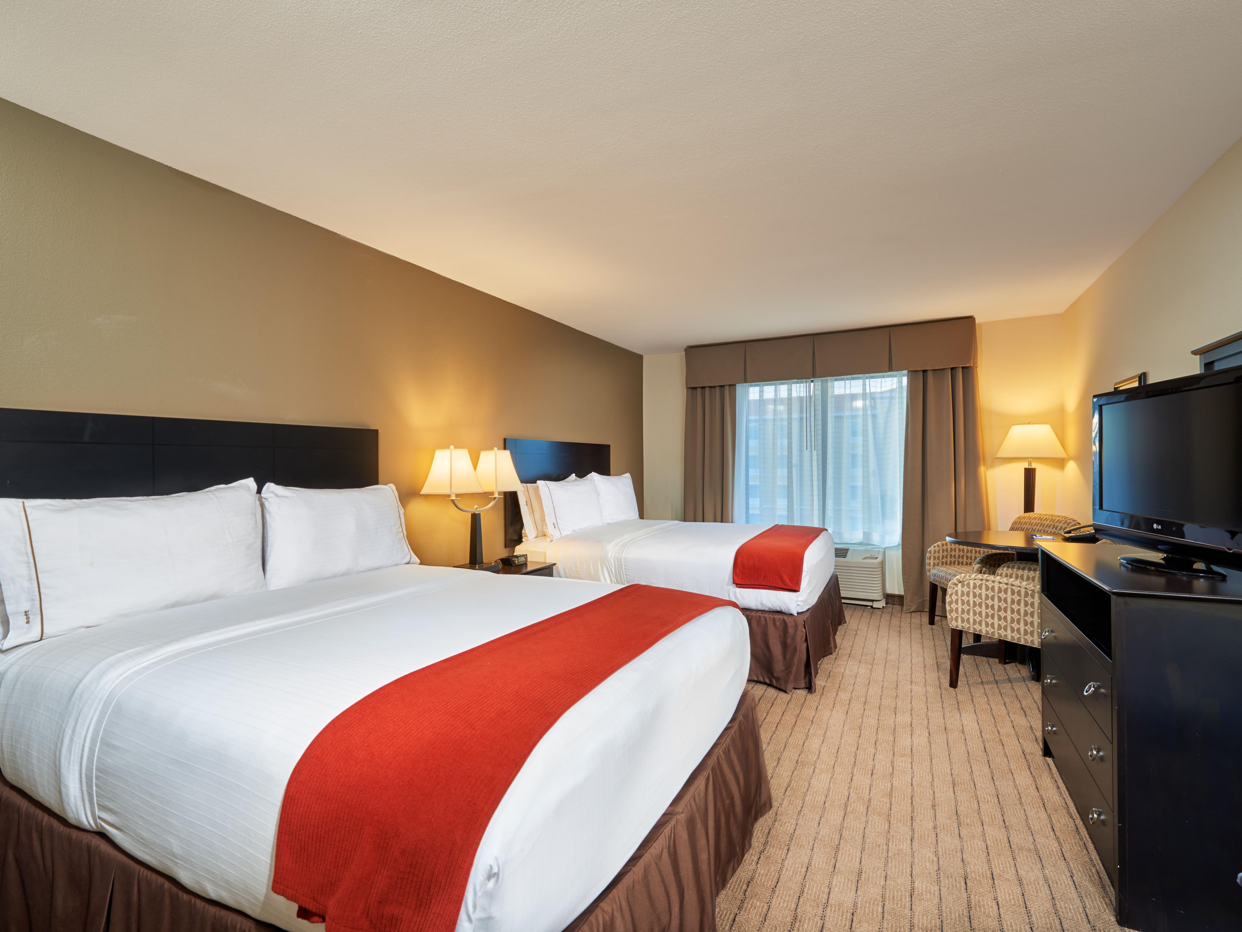 Our queen/queen guest room with crisp linens and flat-screen TV