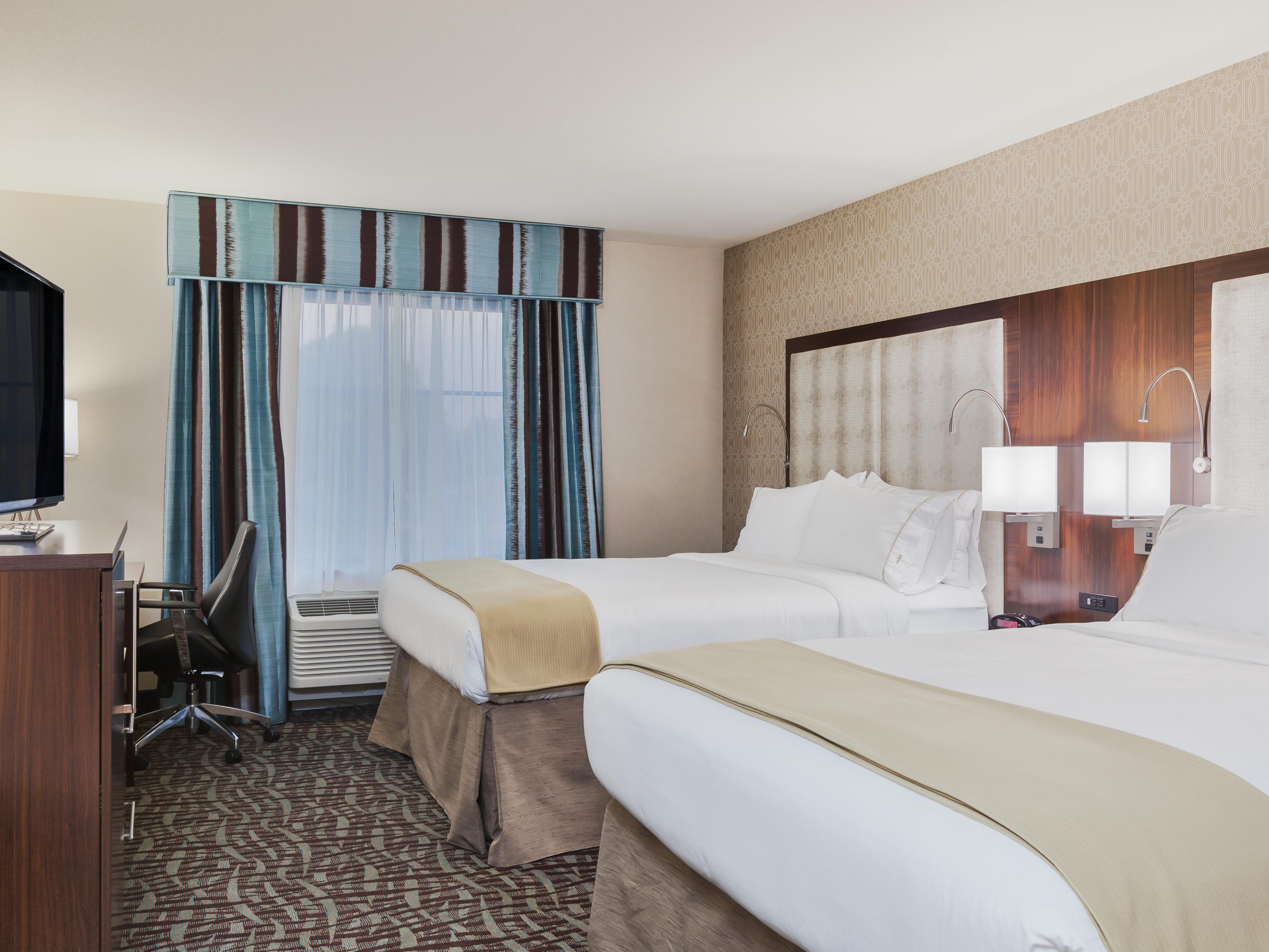 Two Queen Bed Guest Room with 46" TV, microwave and refrigerator.