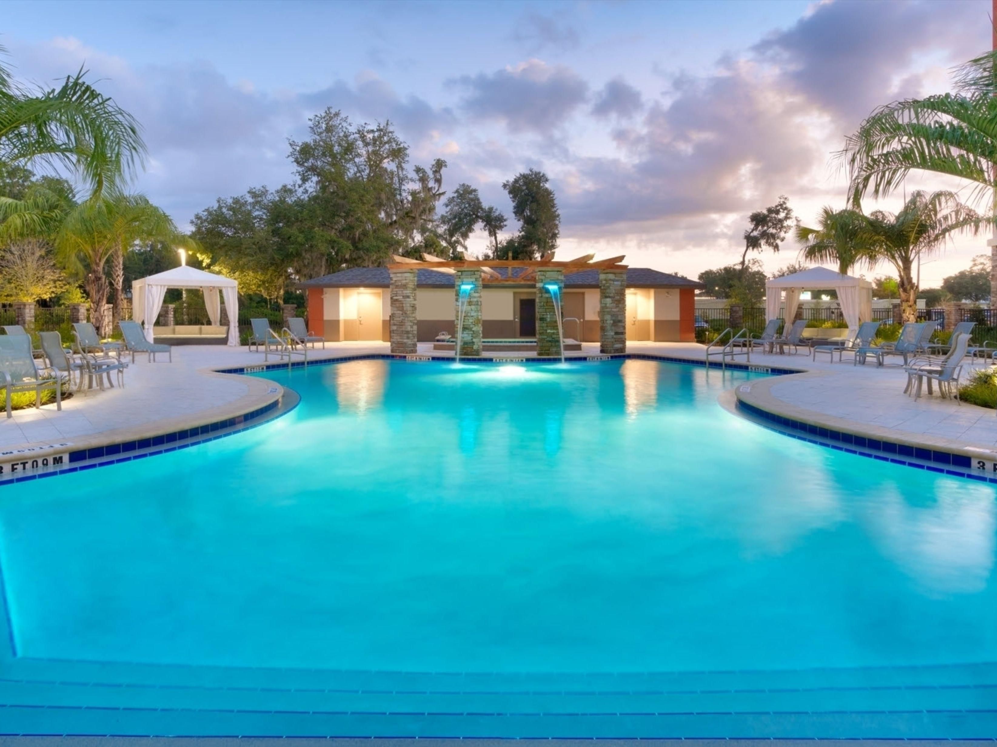 Outdoor pool area with hot tub and plenty of seating!