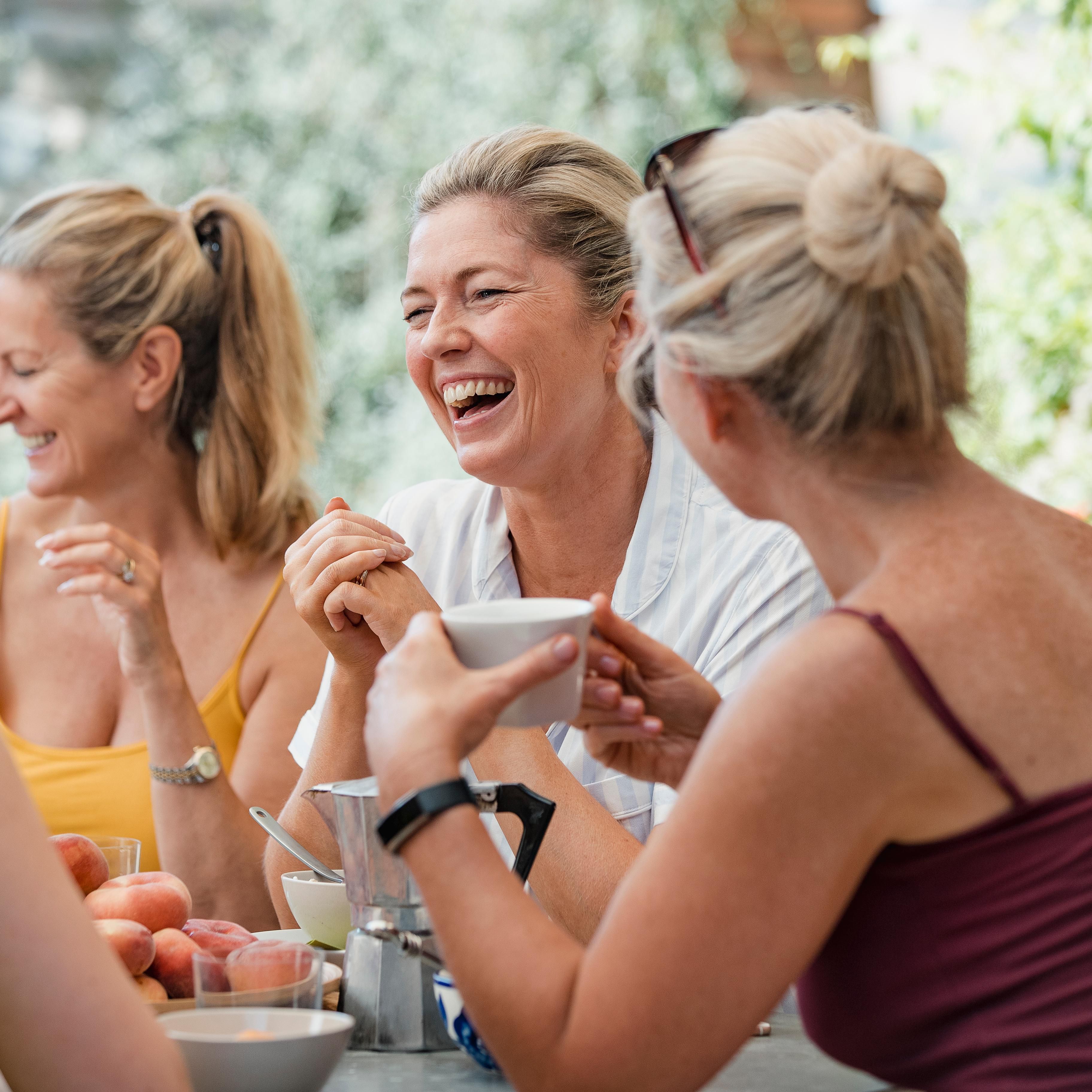 Girls having breakfast and coffee together happy