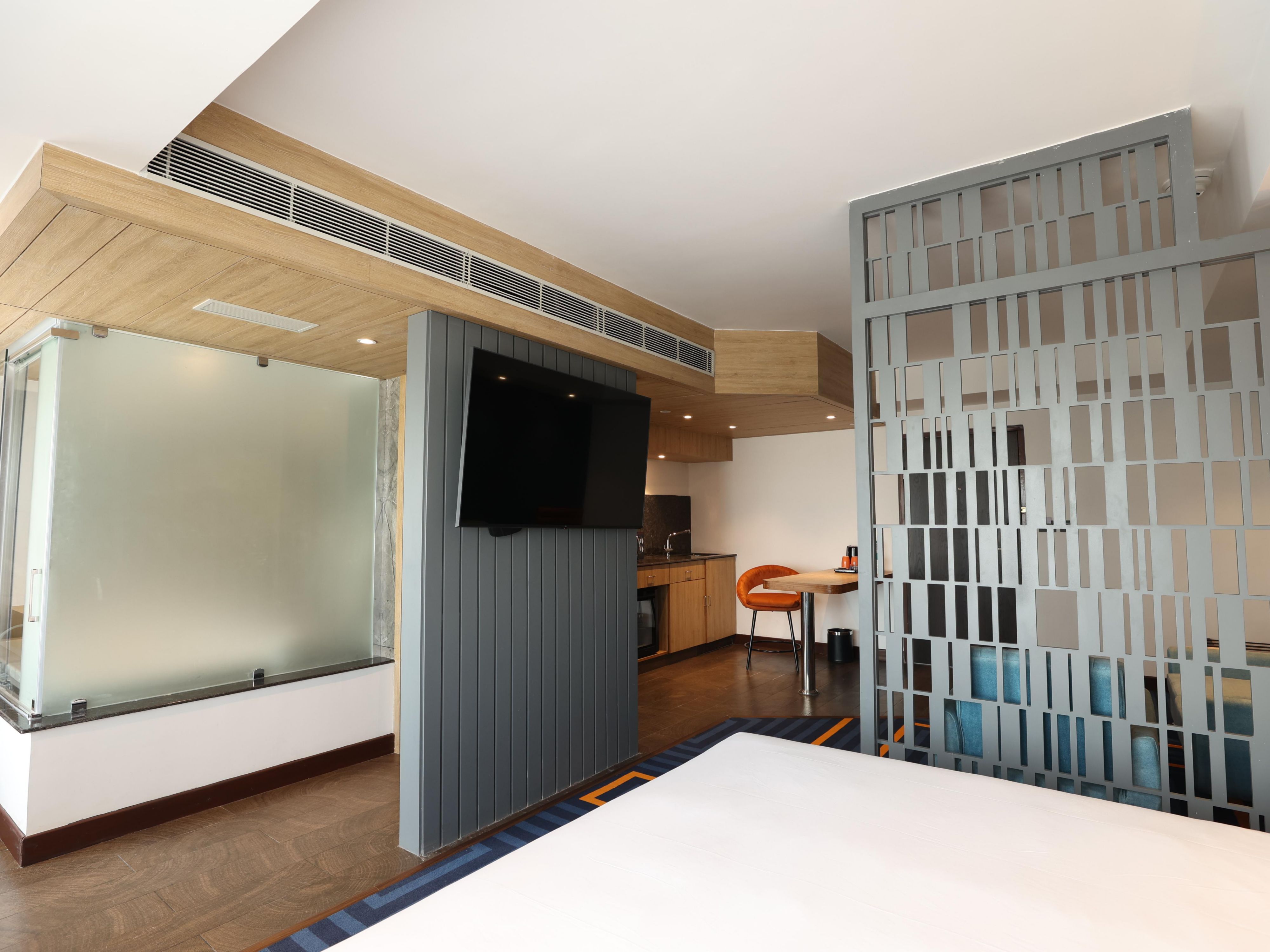 Experience luxury in our spacious suites with separate living, dining, and kitchen areas. Enjoy top amenities like a microwave, mini fridge, iron, ironing board, and tea/coffee maker. Watch your favorite shows on a 43-inch LED Smart TV or work with ease at your desk with free Wi-Fi for added comfort and convenience.