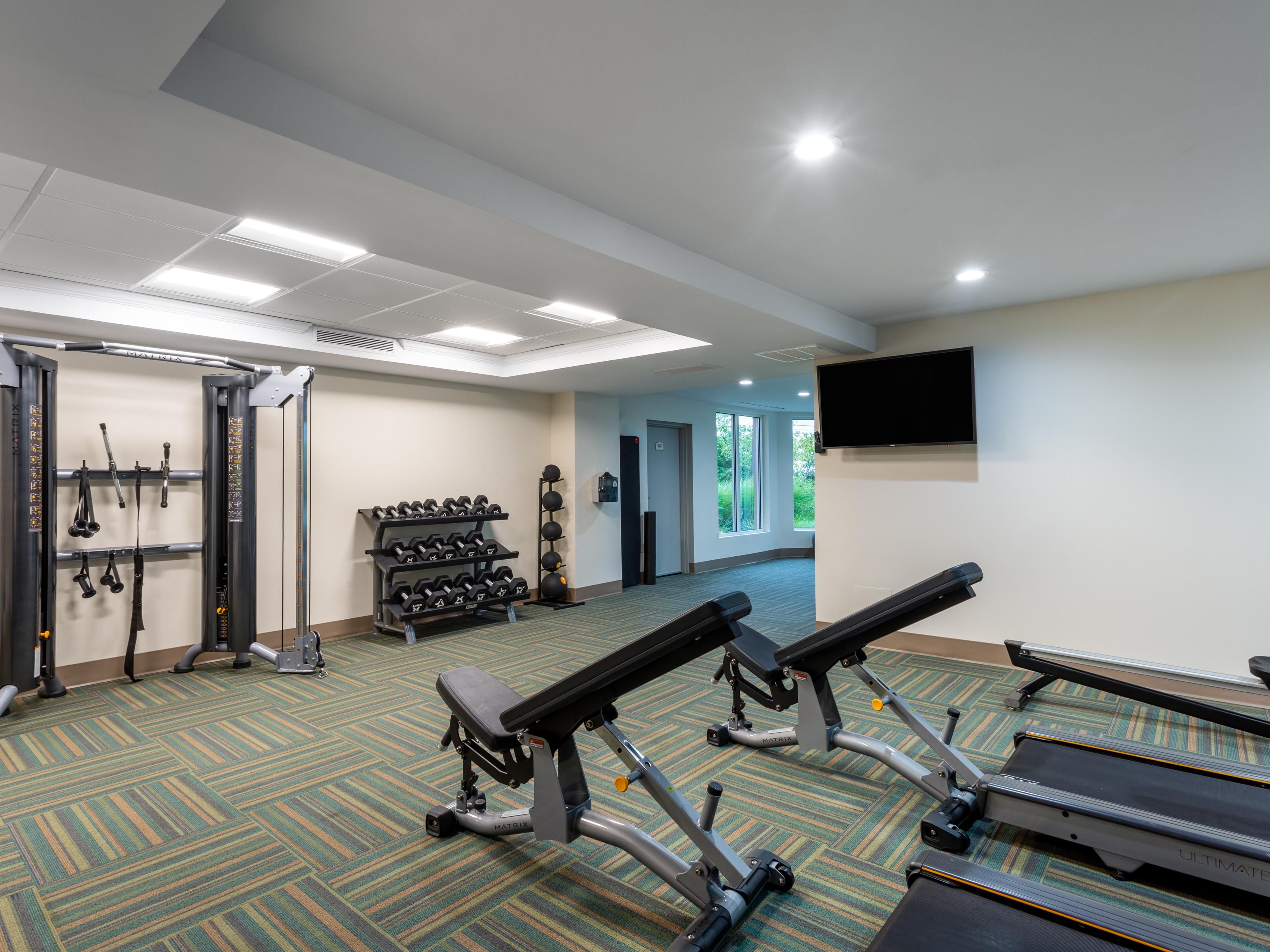 Fitness Center featuring weights and expanded cardio options