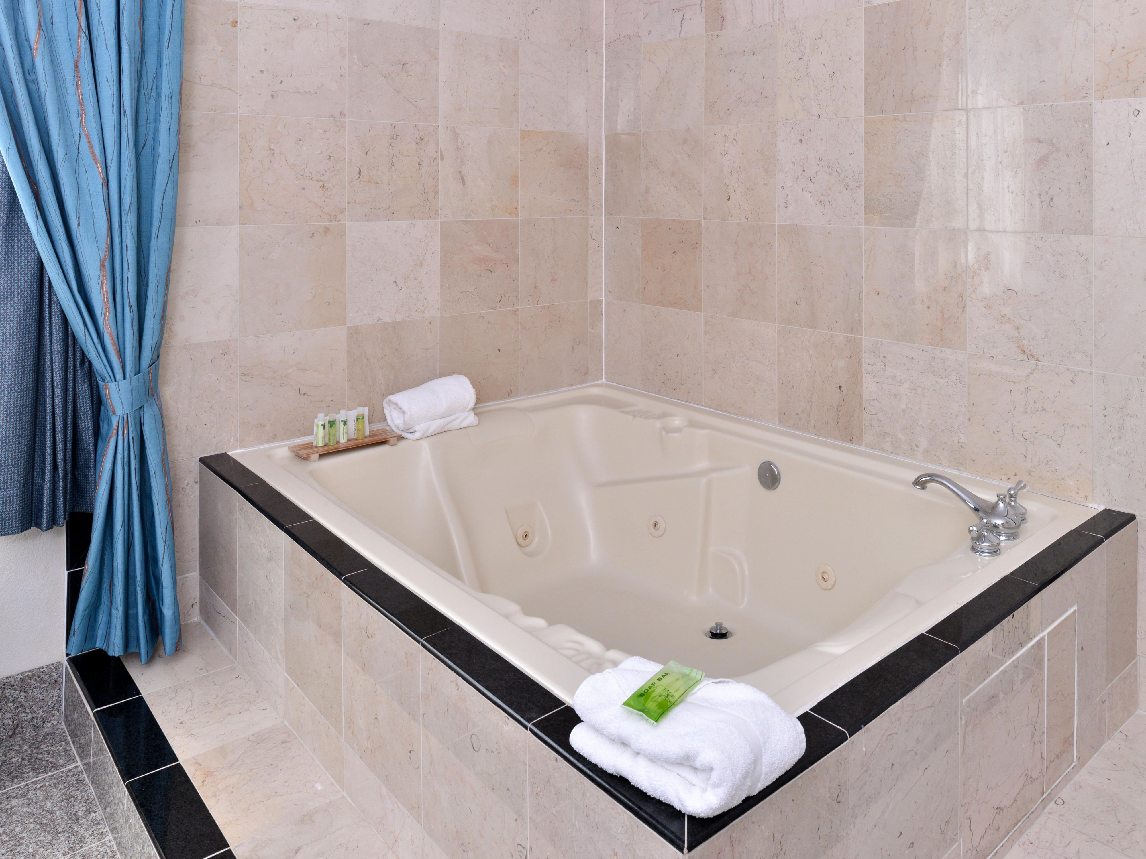 Whether you are in need of deep relaxation or want to treat your love to a romantic getaway, our King Whirlpool Suite room is ready to host you.