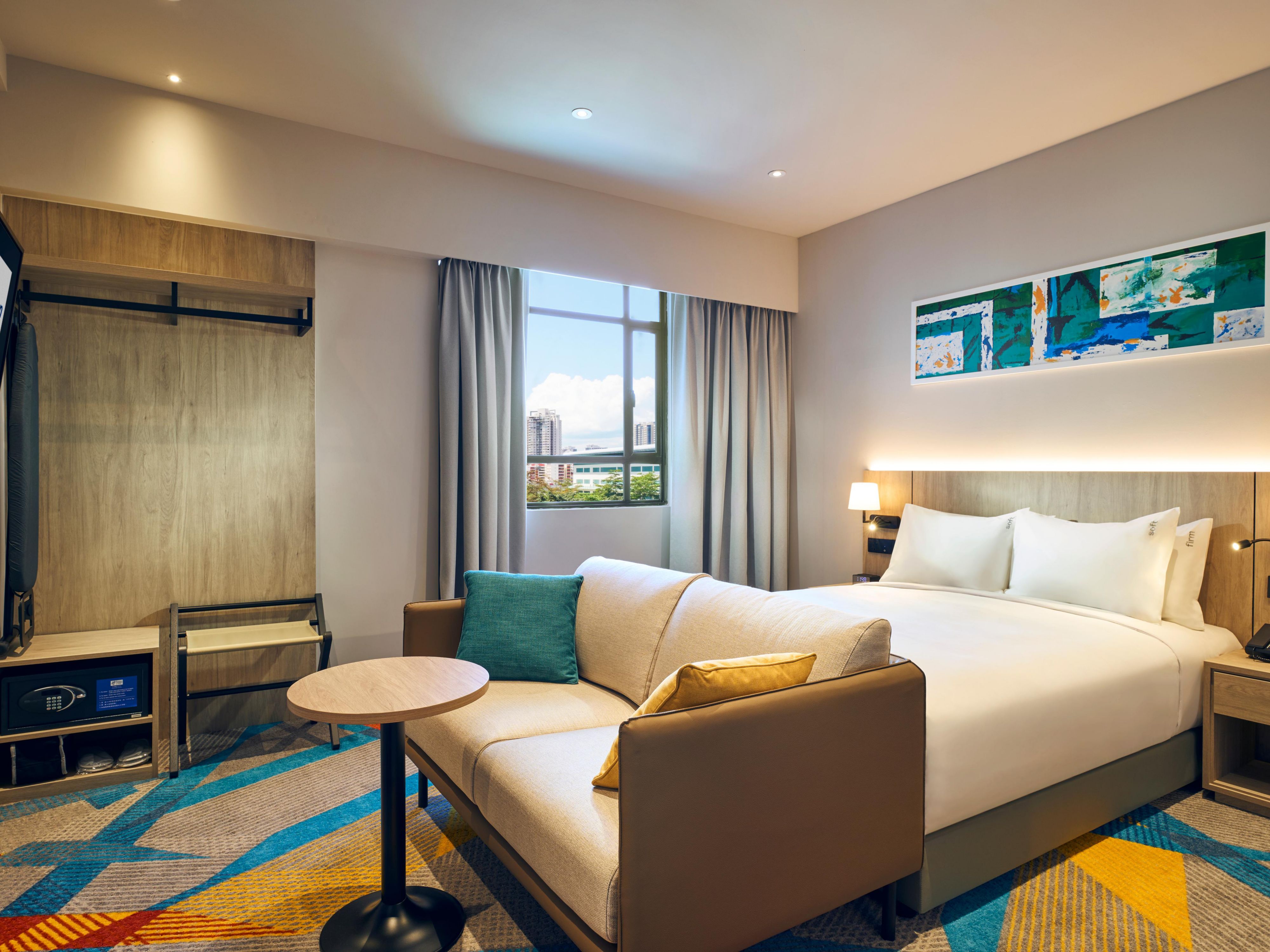 Comfort meets style in our modern rooms and suites. Our suites feature spacious living and dining areas with a sofa and kitchenette. Each room is thoughtfully designed for natural light, ergonomic workspace, free Wi-Fi, and charging points. Enjoy a spa-like shower, adjustable climate control, and premium linens.