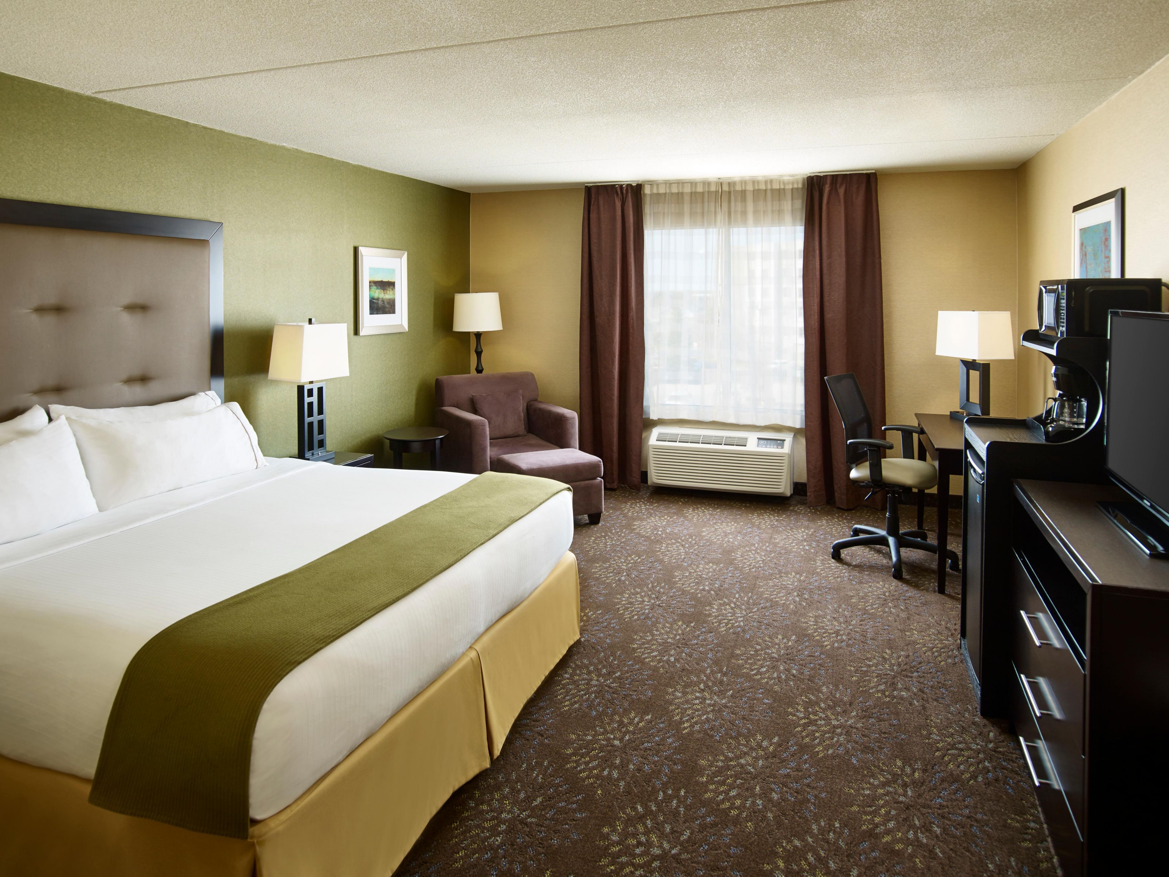 Rest in your spacious Timmins hotel room with a lounge chair.