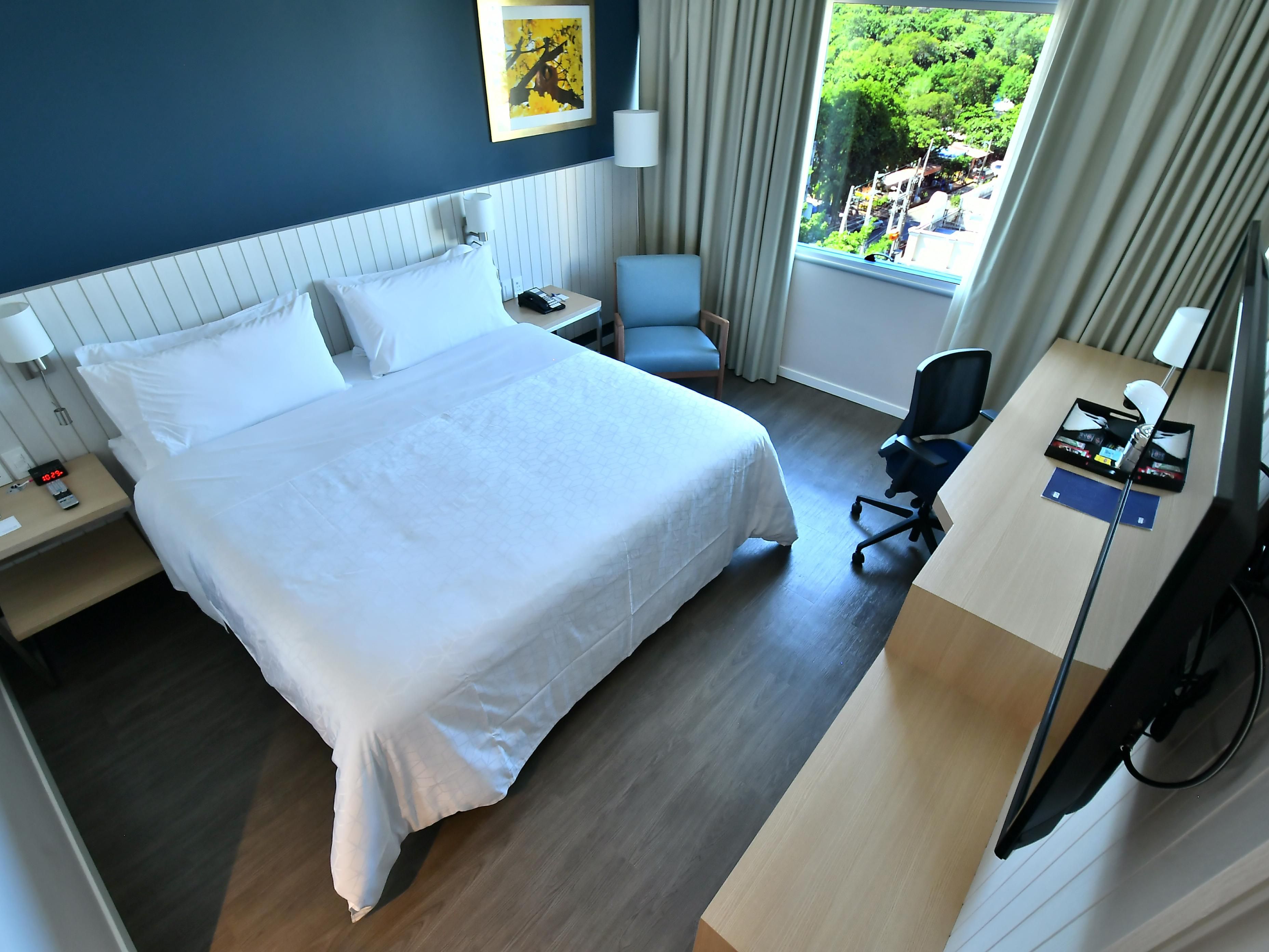 After working at the desk, curl up on our triple-sheeted bed.