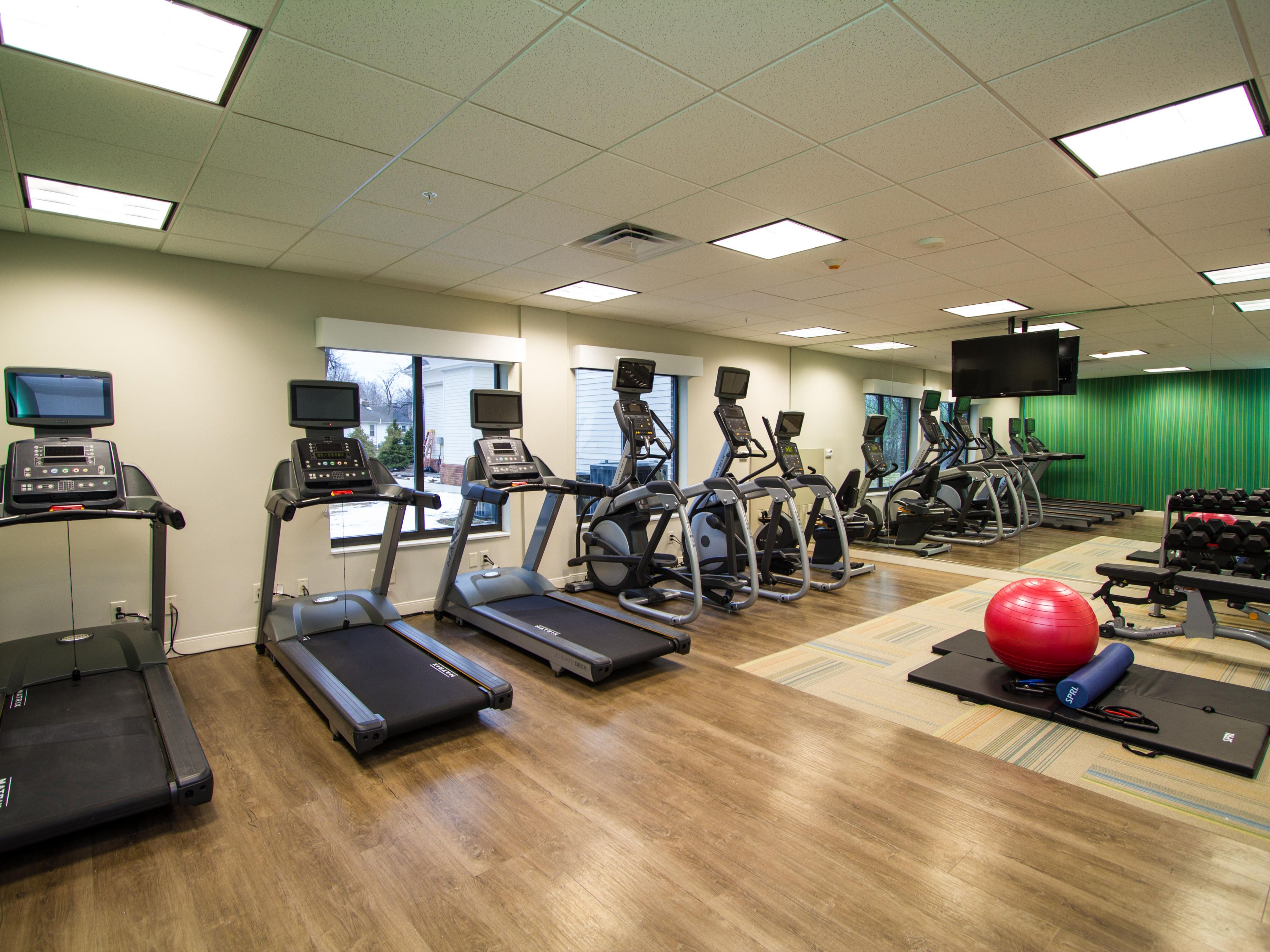 Modern Fitness Center with new machines and stretching area.
