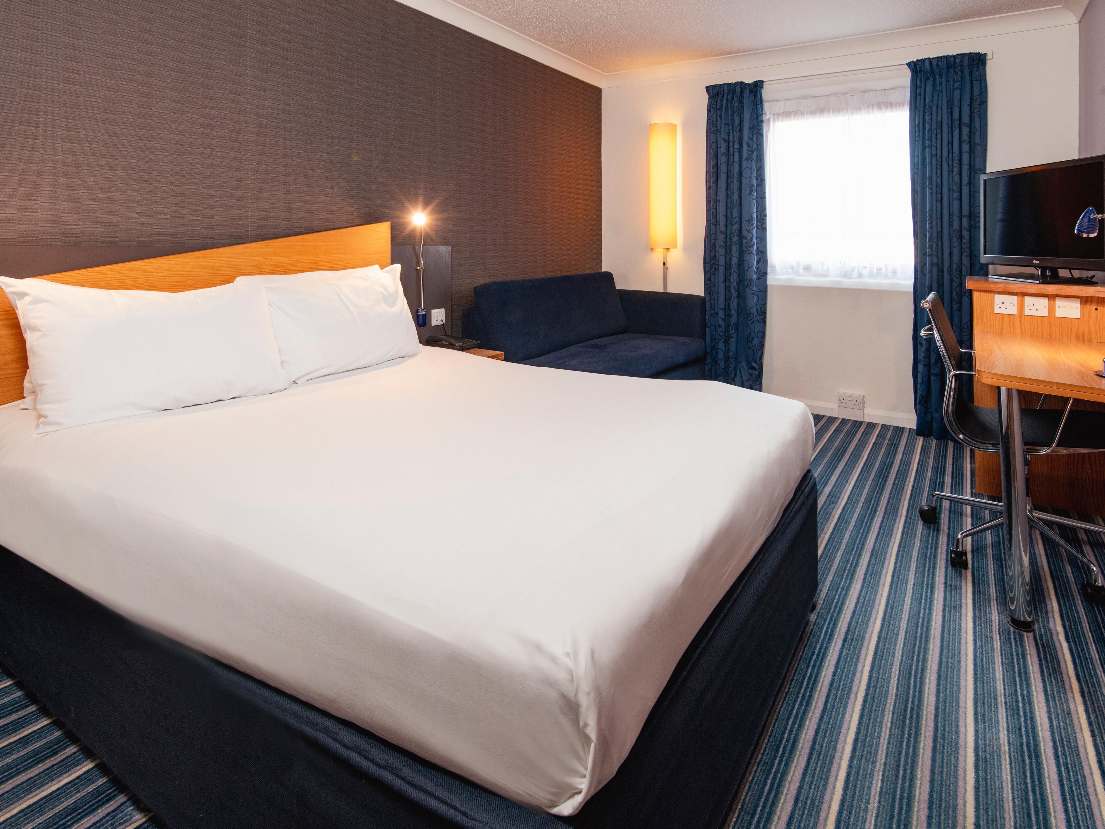 Double rooms feature a double bed, work desk with lamp and TV.