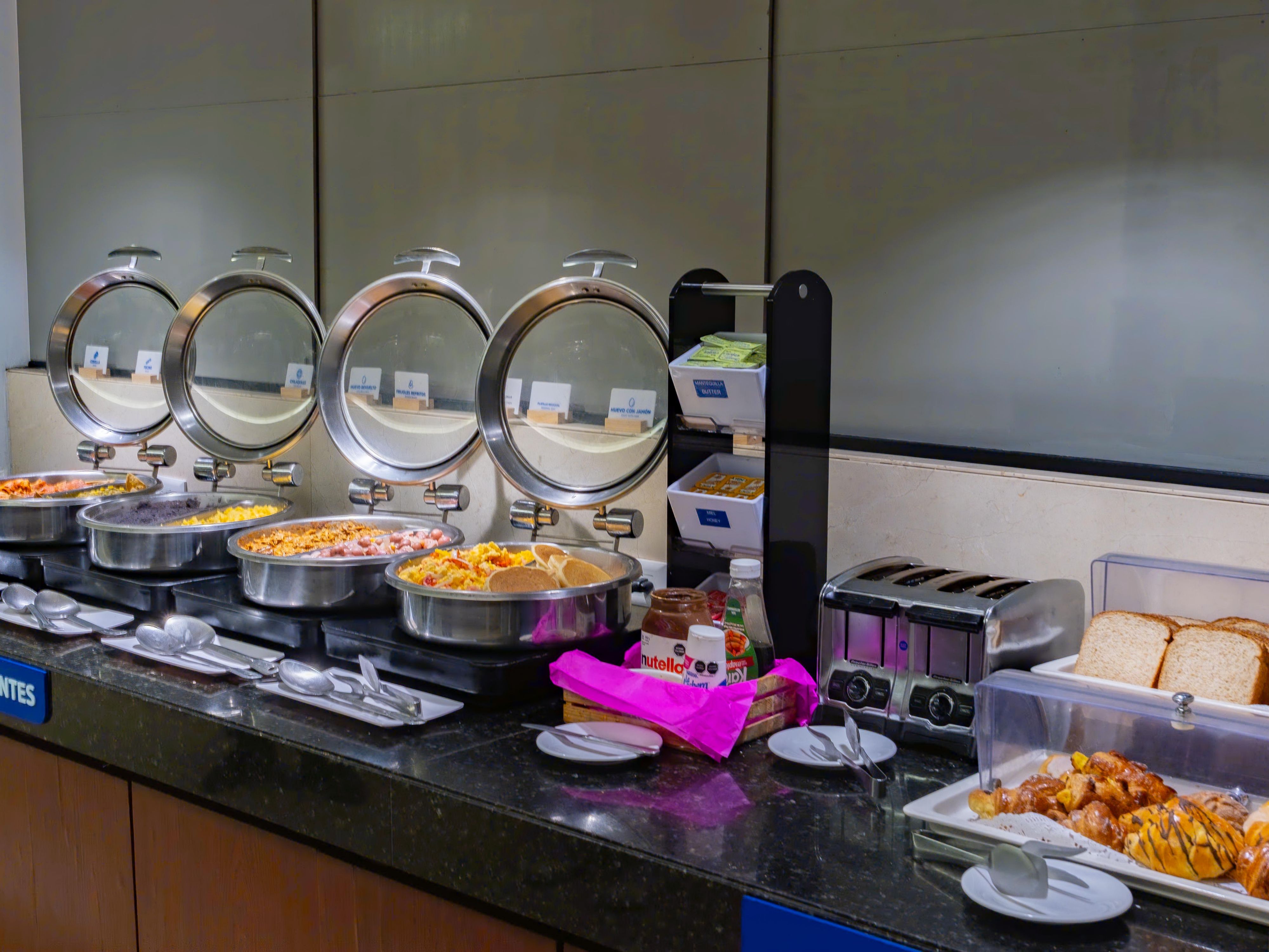 Start your day with our complimentary Express Start Breakfast, featuring juices, coffee, cereal, fruits, eggs, beans, and traditional dishes.