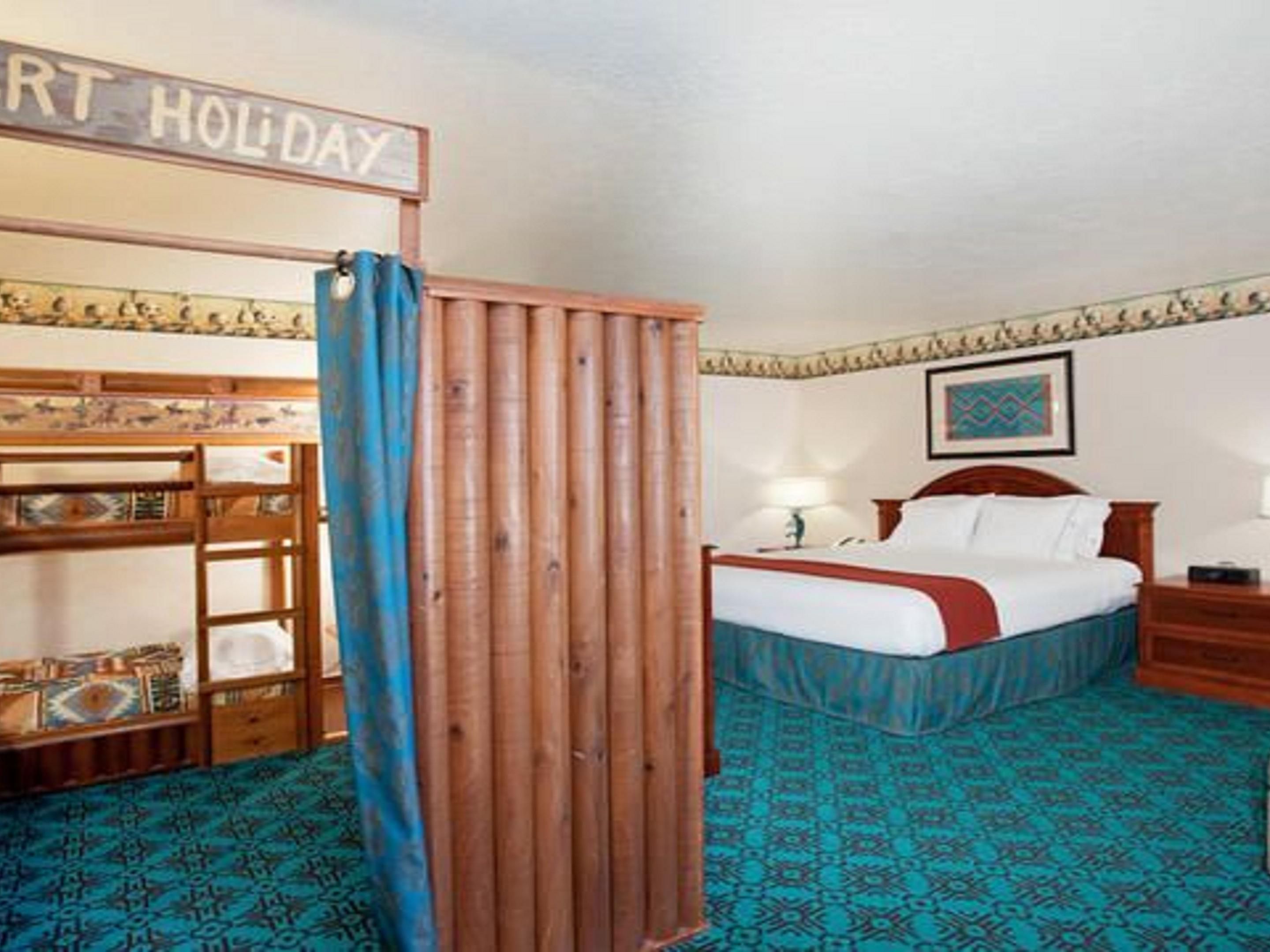 Our King Kids Suite is fun and comfortable for all. Relax while the kids play, modeled after an old west fort, there is two sets of junior bunk beds and a Play Station 3 included for the kids entertainment. 