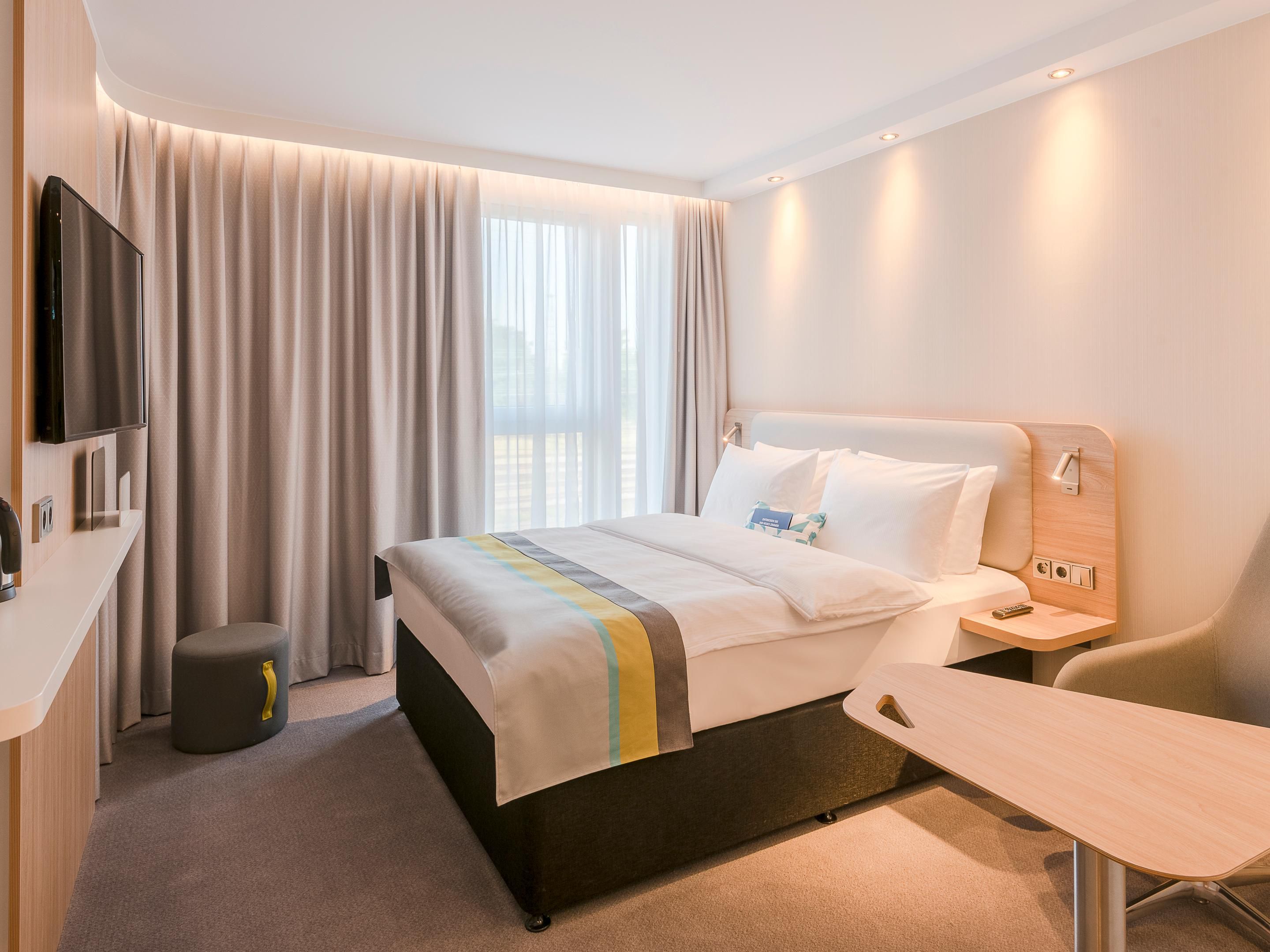Our quiet, next-generation rooms have blackout curtains and comfortable beds for restful nights. Decorated in soft hues with bold accents, they offer smart TVs and bedside USB ports. Wi-Fi is included. All family rooms have sofa beds for your children.