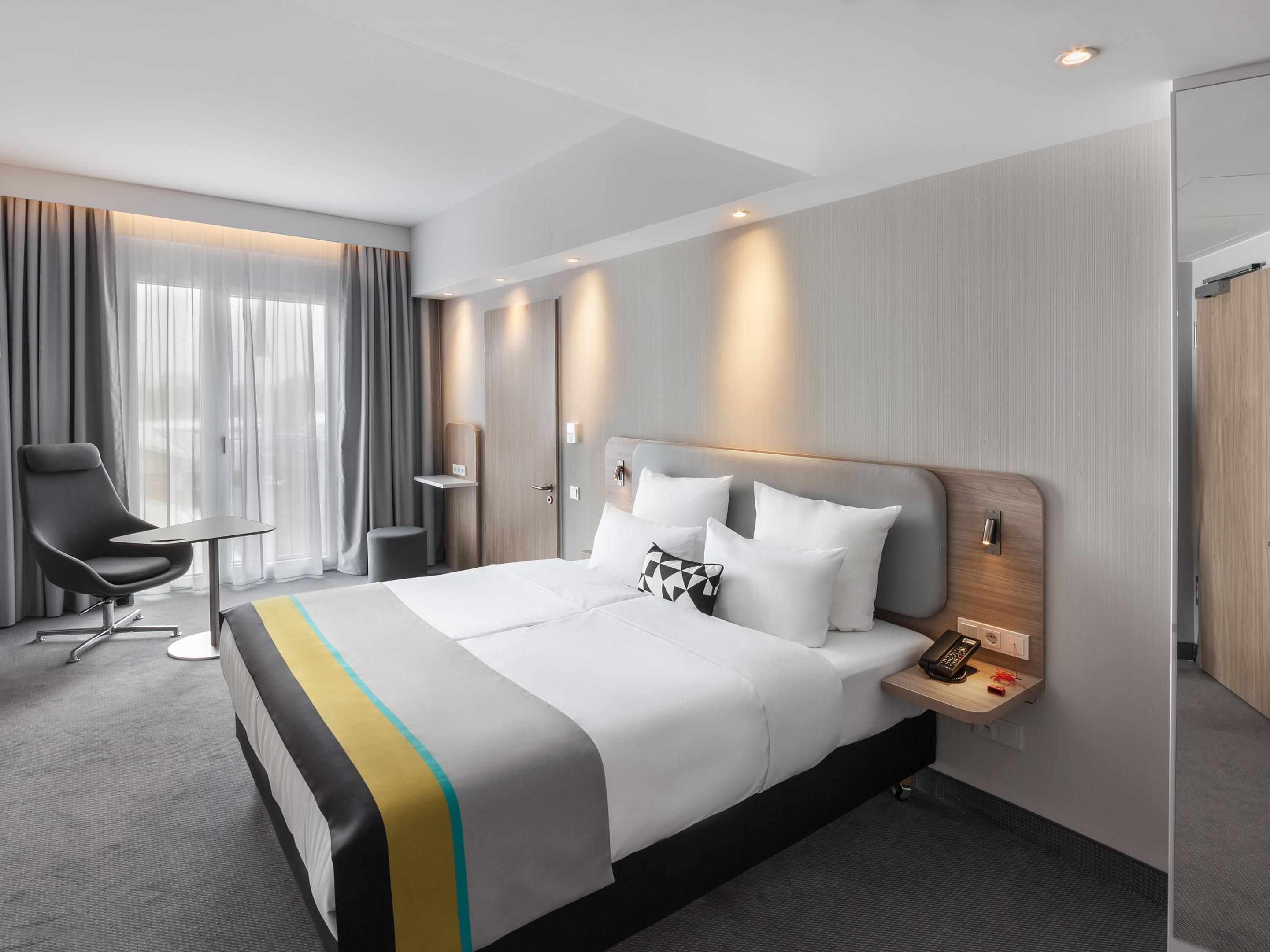 Air-conditioned Next Generation bedrooms feature comfortable bedding, blackout curtains, USB charging points, and an ergonomic workspace. Enjoy complimentary coffee and tea, a Smart TV, in-room safe, free Wi-Fi, and more for a comfortable and productive stay. 