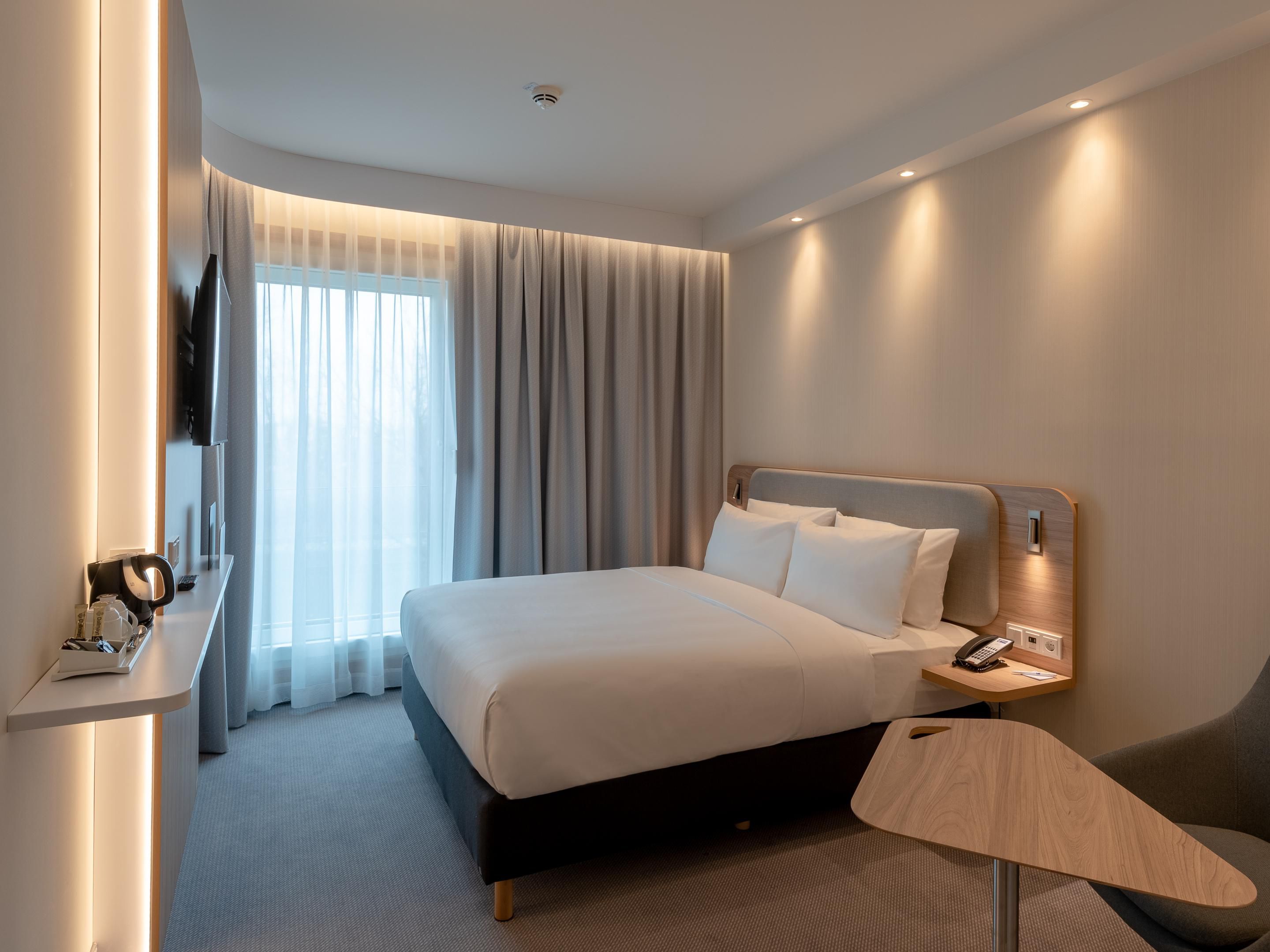 Air-conditioned Next Generation bedrooms feature comfortable bedding, blackout curtains, USB charging points, and an ergonomic workspace. Enjoy complimentary coffee and tea, a Smart TV, in-room safe, free Wi-Fi, and more for a comfortable and productive stay. 