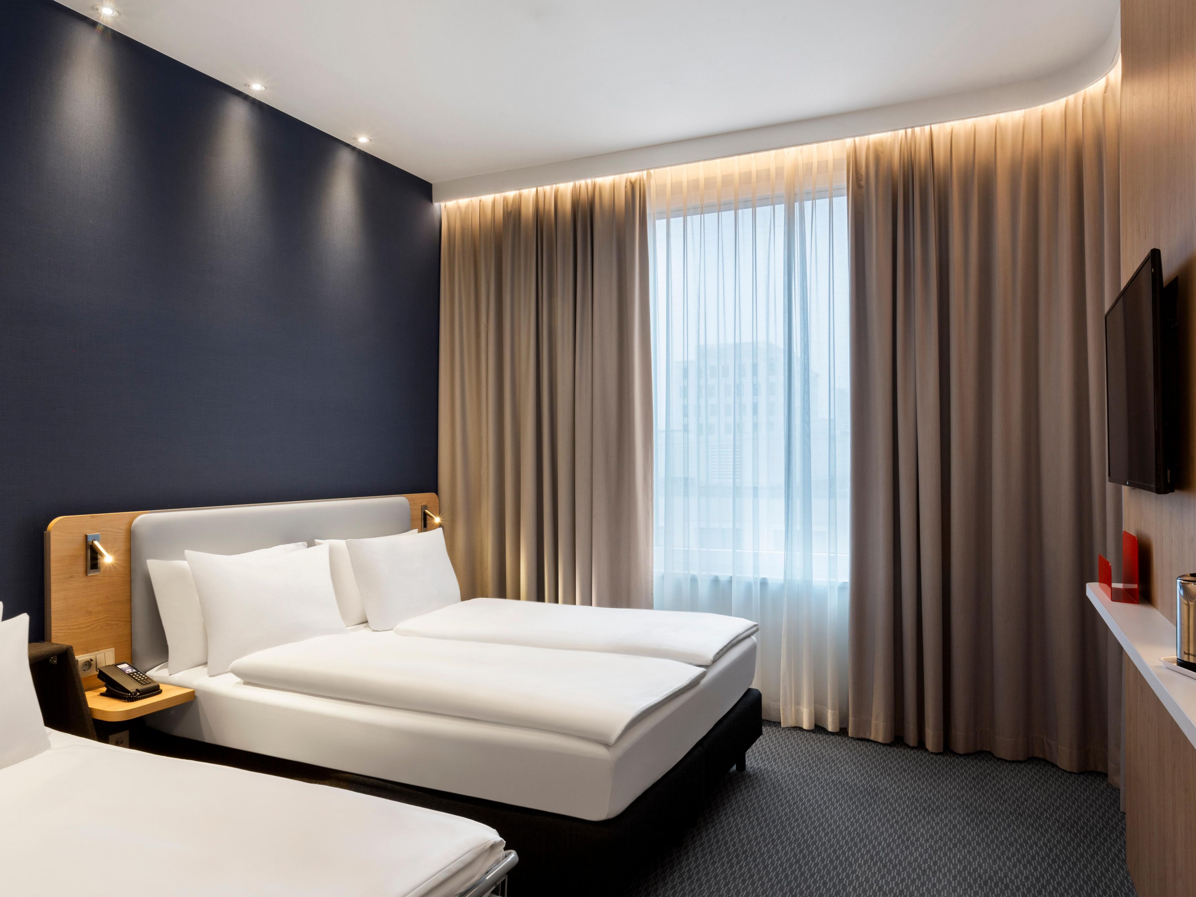 Enjoy our family rooms for a fun experience in Munich especially in summer. Unwind in rooms that include a double sofa bed,  complimentary Wi-Fi, air conditioning, flat-screen TV, and a mobile desk.