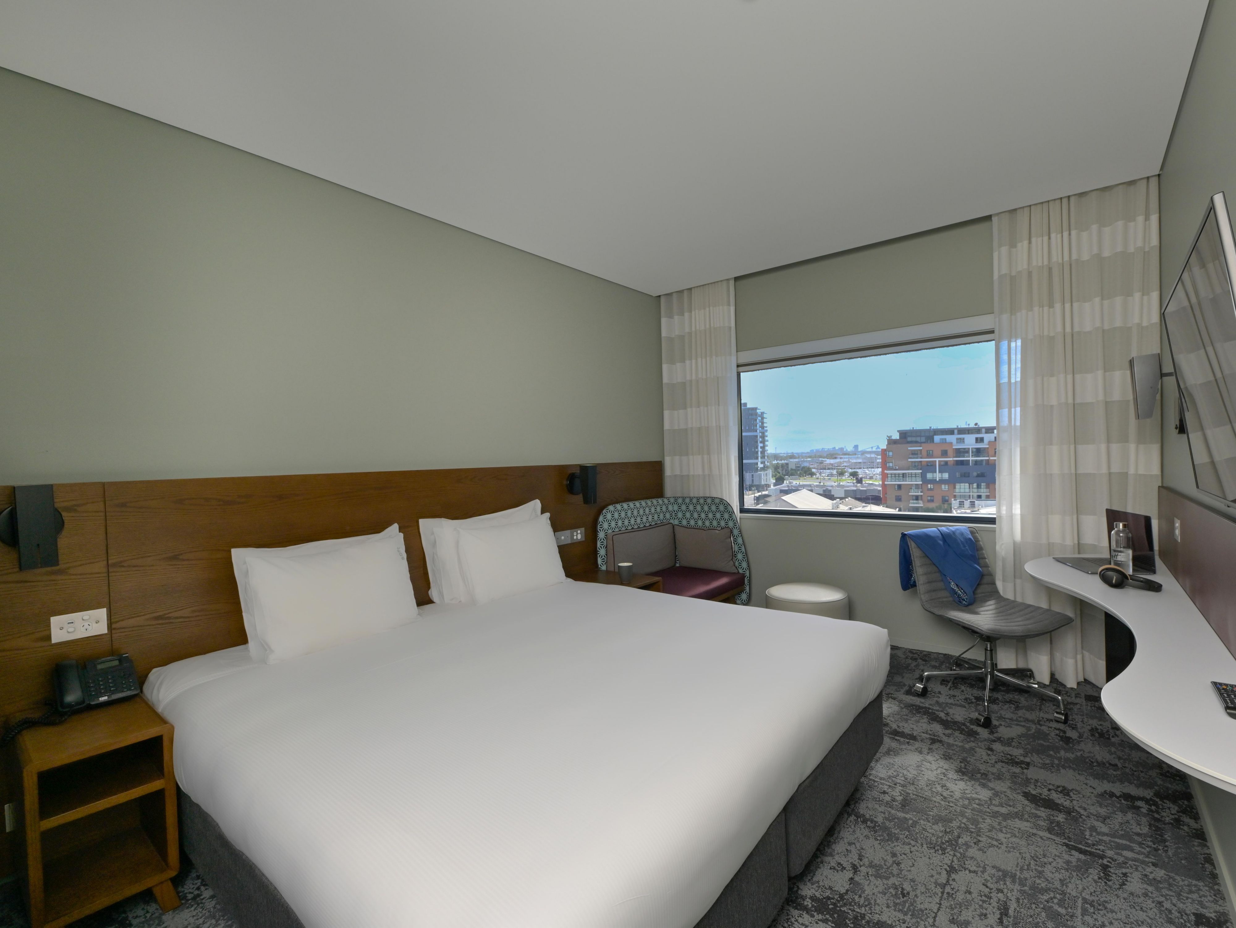 Smartly designed guest room with workspace and city views