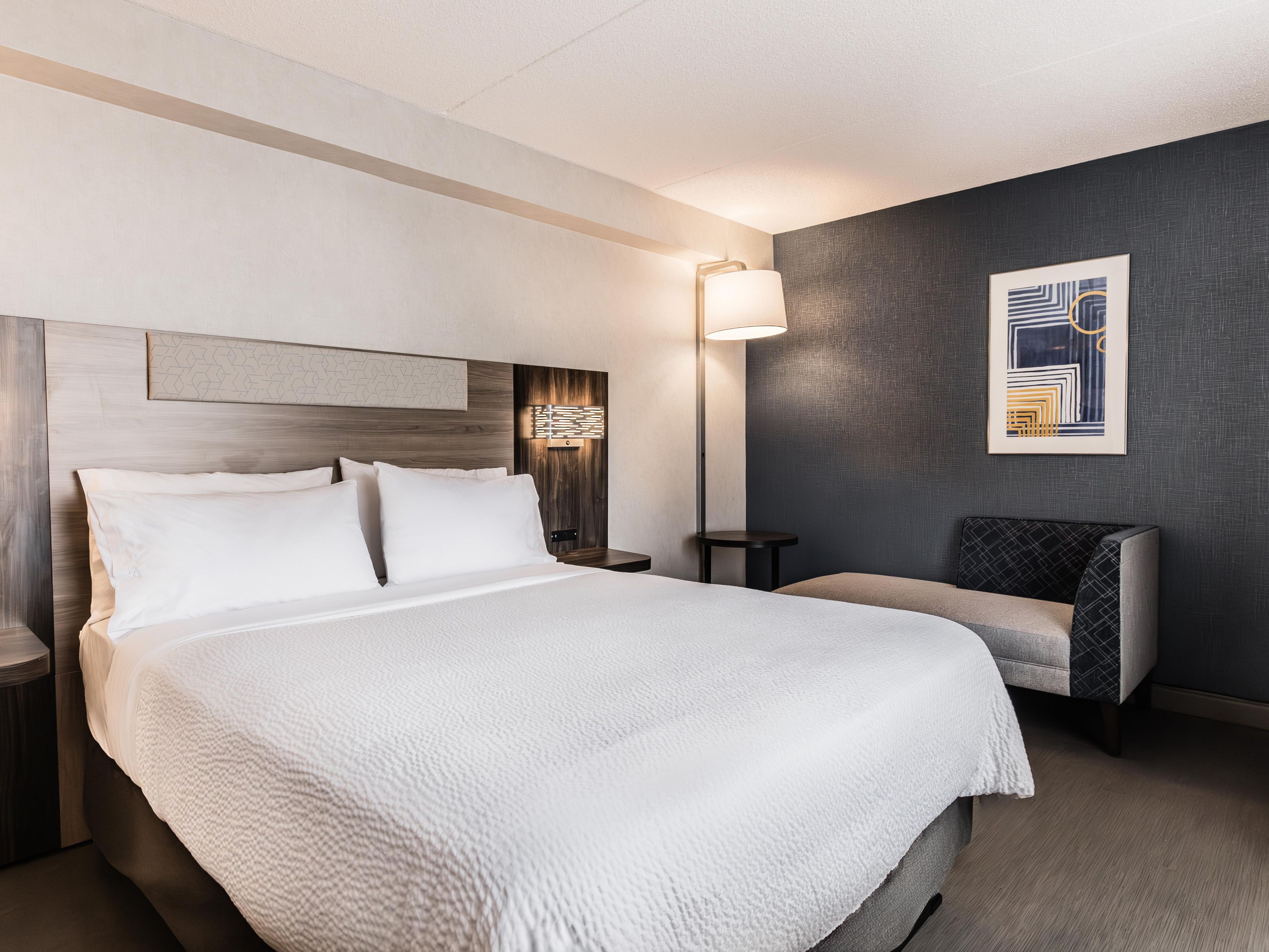 Our Queen bed guest room offers a comfortable and well-lit space.