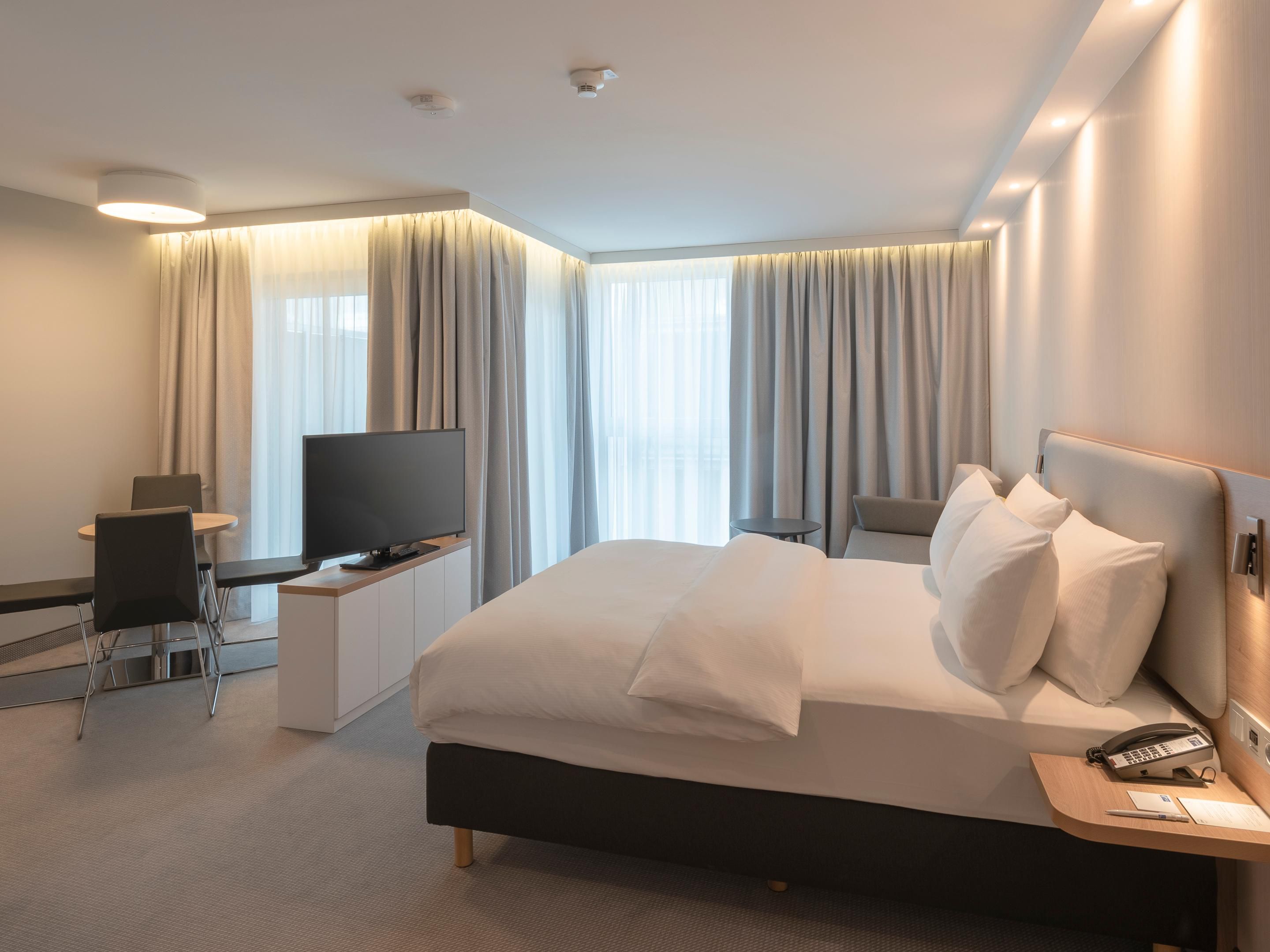Air-conditioned Next Generation bedrooms feature comfortable bedding, blackout curtains, USB charging points, and an ergonomic workspace. Enjoy complimentary coffee and tea, a Smart TV, in-room safe, free Wi-Fi, and more for a restful and productive stay. 