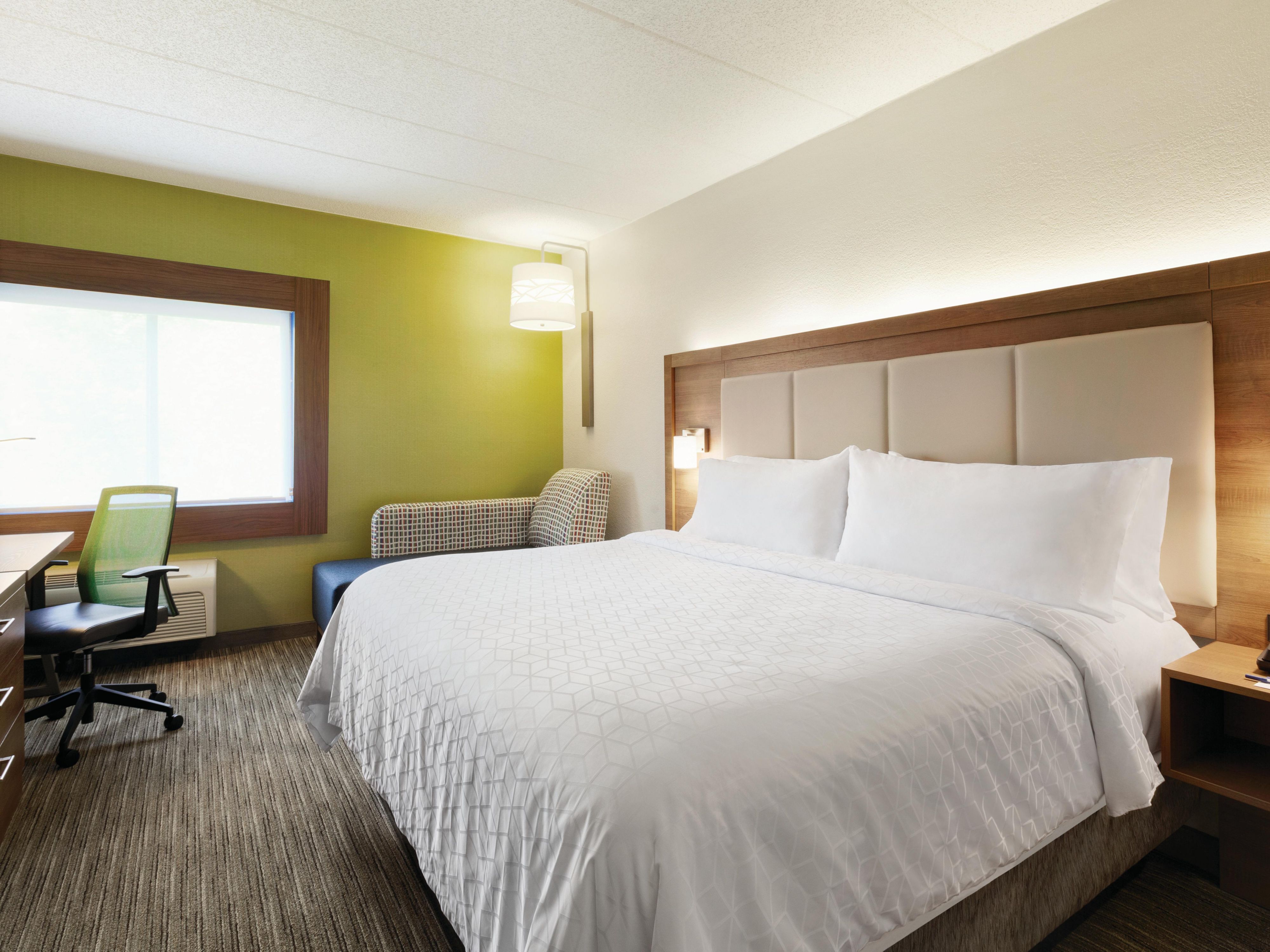 Recharge in our king room featuring plush duvets and pillows