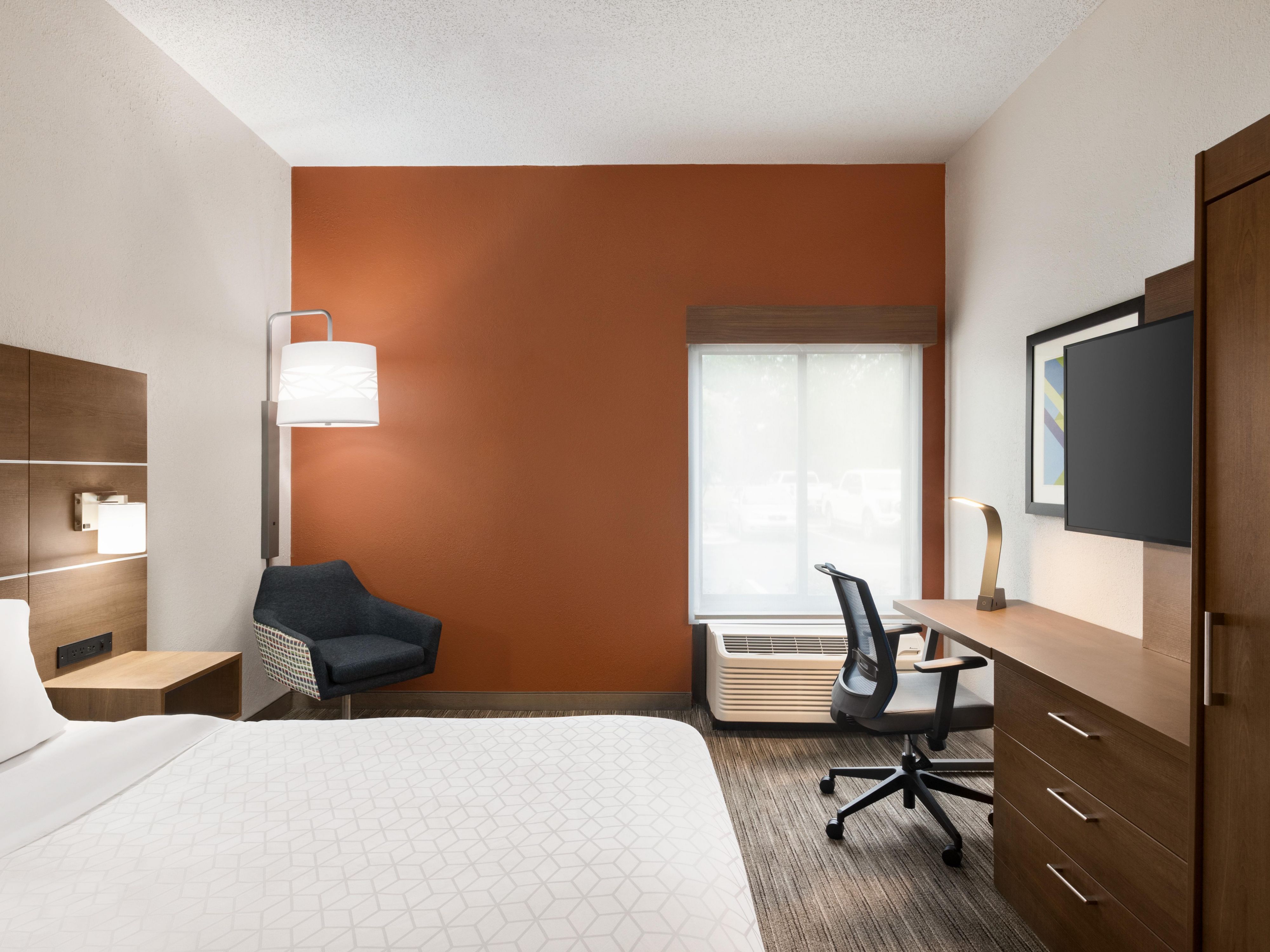 Guest room with plush bedding & productive workspace.