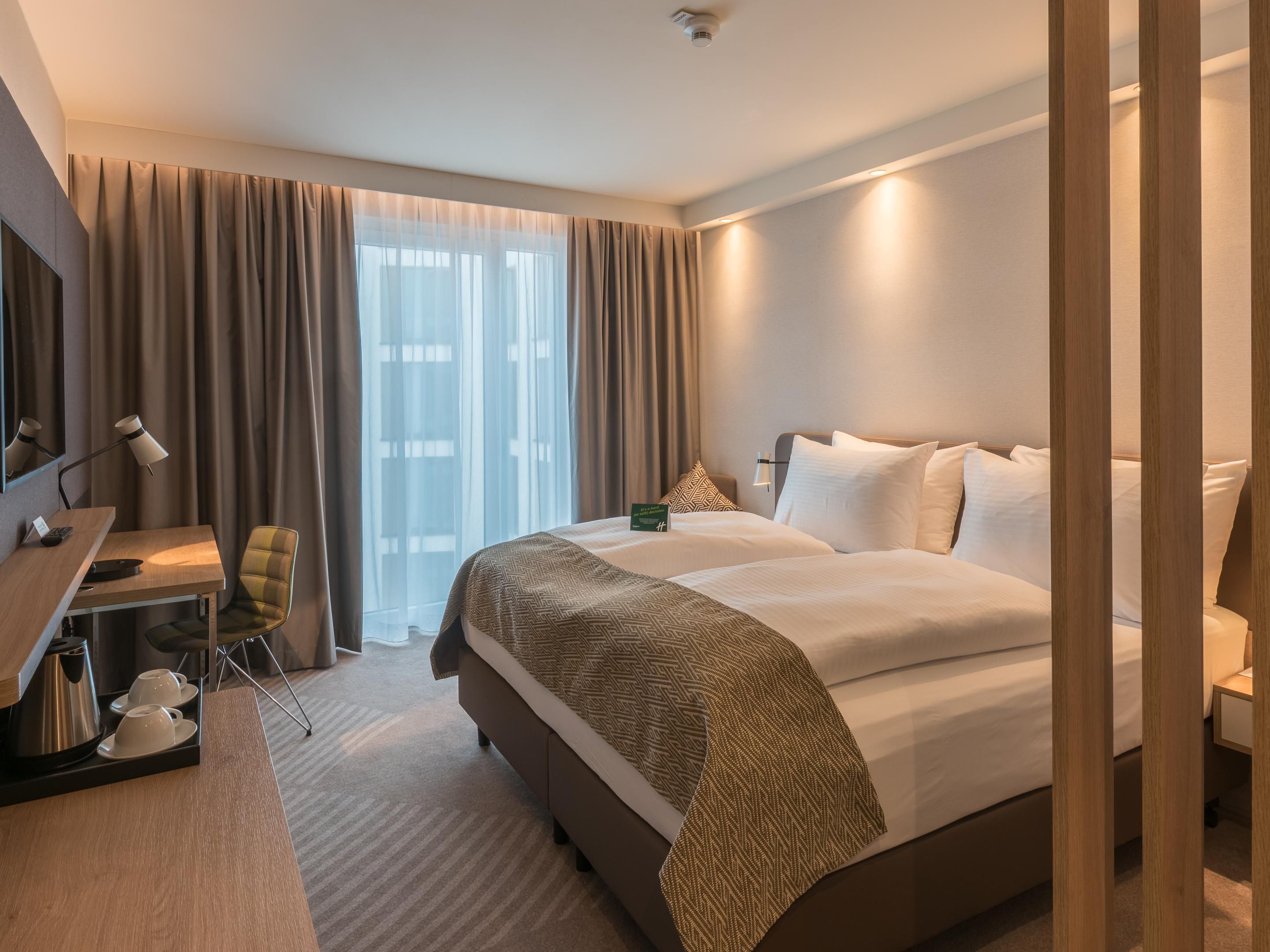 Air-conditioned rooms feature premium bedding, blackout curtains, USB charging points, and an ergonomic workspace. Unwind with your favorite shows on the flat-screen TV. Additional amenities include complimentary tea and coffee, an in-room safe, free Wi-Fi, and more. 