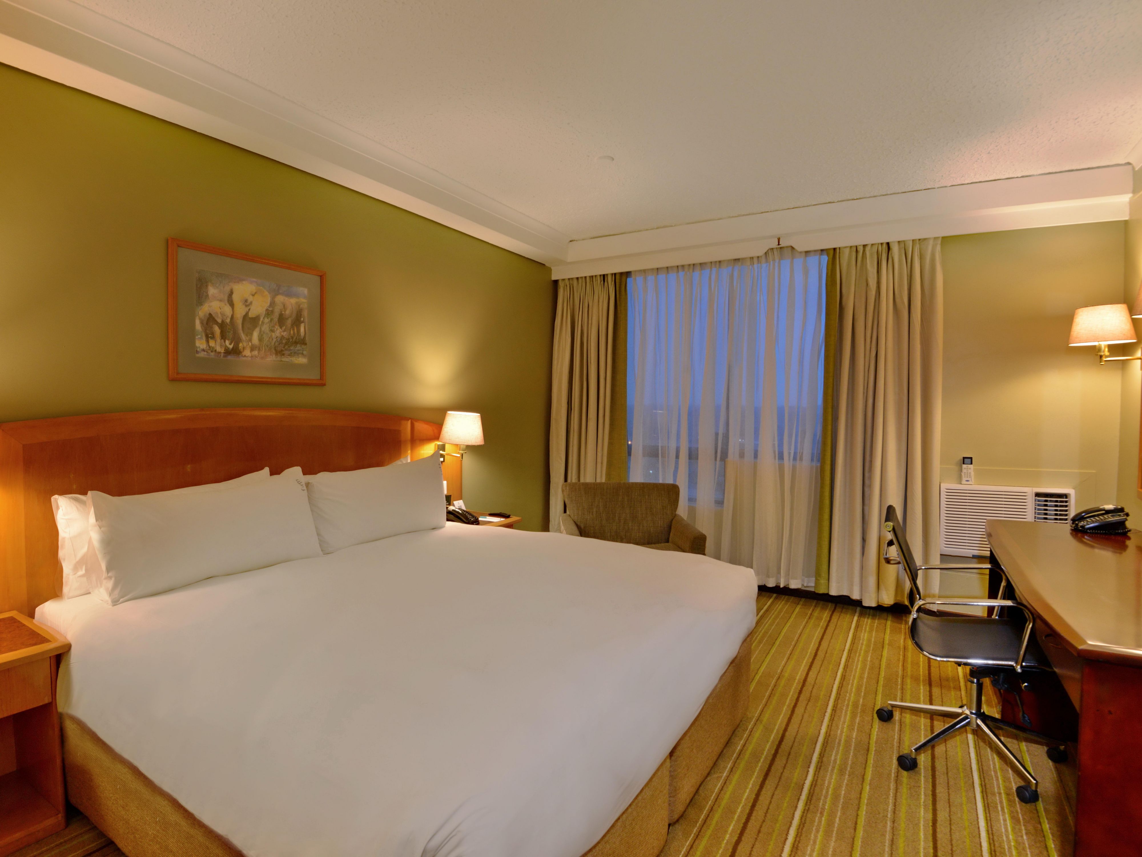 Experience ultimate relaxation in our beautifully designed guest rooms, featuring clean decor, and spacious layouts. Each room comes equipped with air conditioning, satellite TV, and complimentary Wi-Fi, ensuring you stay connected and comfortable. Enjoy thoughtful amenities like tea, coffee, and mineral water to make your stay truly enjoyable.