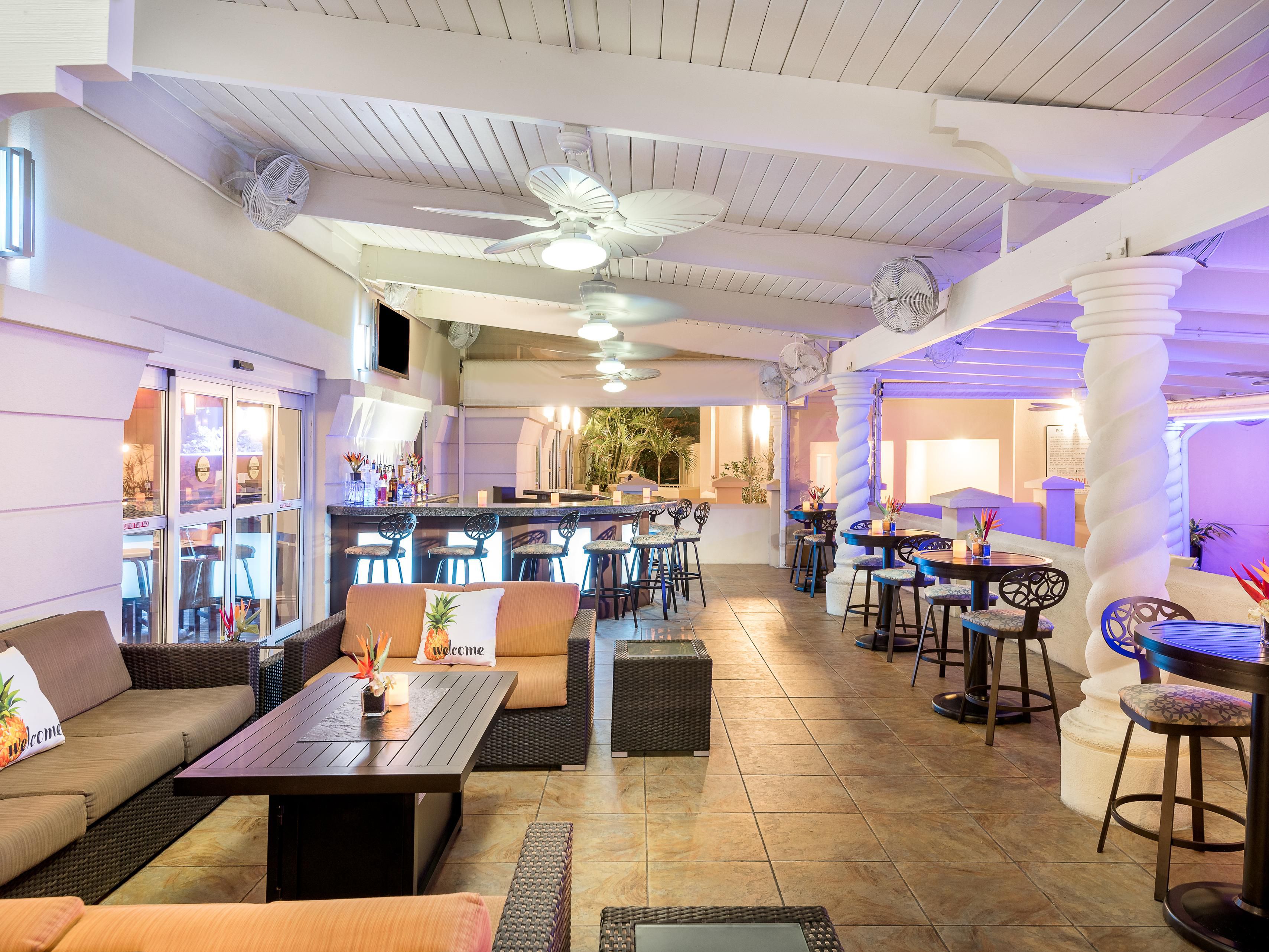 Relax in our outdoor tropical lounge, where you can enjoy the soothing sounds of our waterfall in the lush pool area. Savor trendy cocktails, a wide selection of alcoholic beverages, delectable appetizers, and ice-cold beer. The Rendezvous Reef Lounge is the perfect spot to unwind and socialize in paradise!