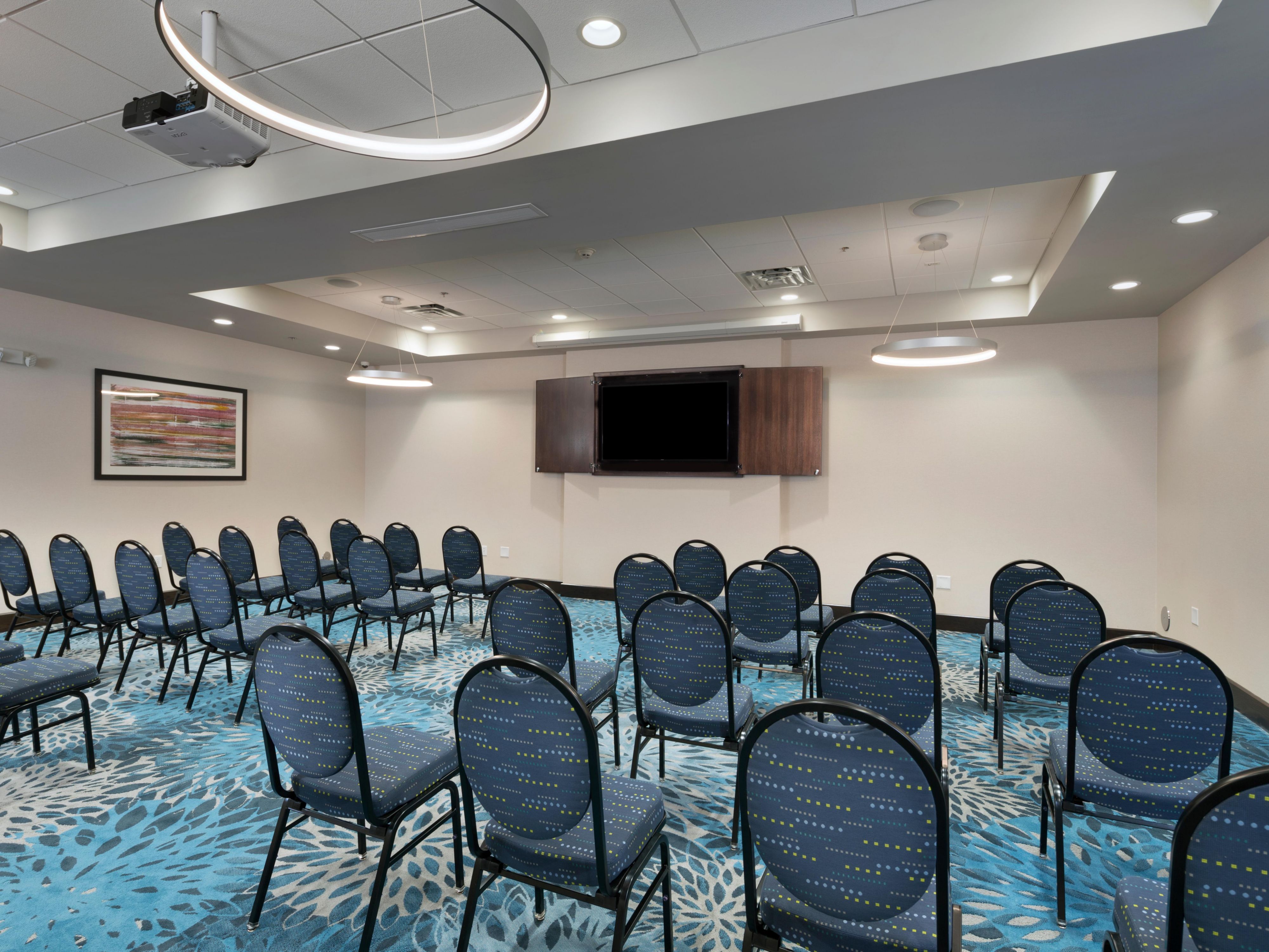 Elevate your event with our spacious 1,820 sq. ft. meeting room for up to 100 guests. This flexible venue, with AV equipment, four 65" TVs, and two drop-down projection screens, can be divided into two rooms for smaller gatherings or breakout sessions. From business meetings and banquets to reunions and weddings, we make your events unforgettable.