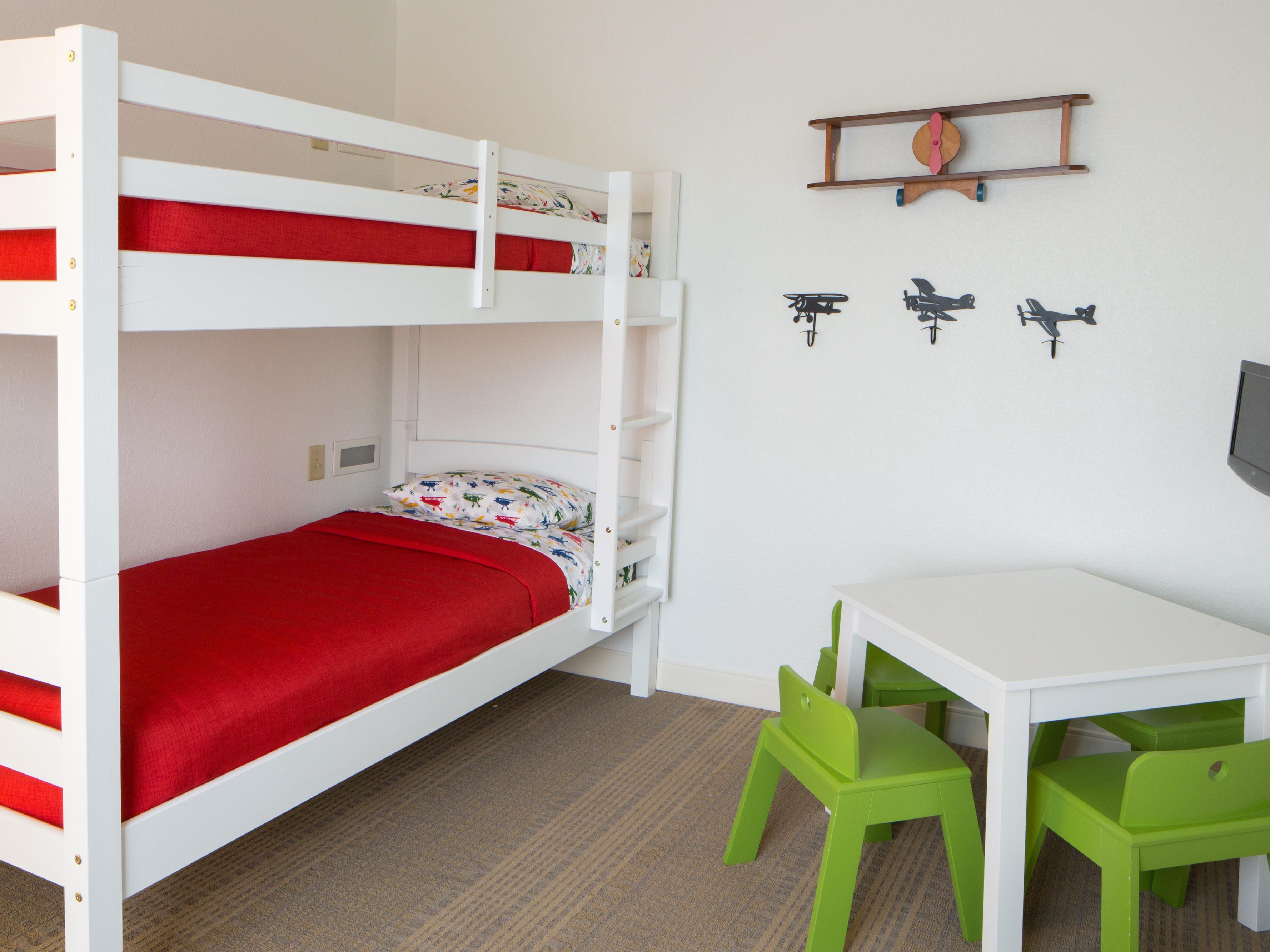 Traveling with kids just got a whole lot more exciting! Our family suites are designed to keep the little ones happy and entertained. Step inside, and at first it looks like a normal hotel room, but with a fun twist. There's a separate space with bunk beds, a TV, and an activity table that your kids will absolutely love!