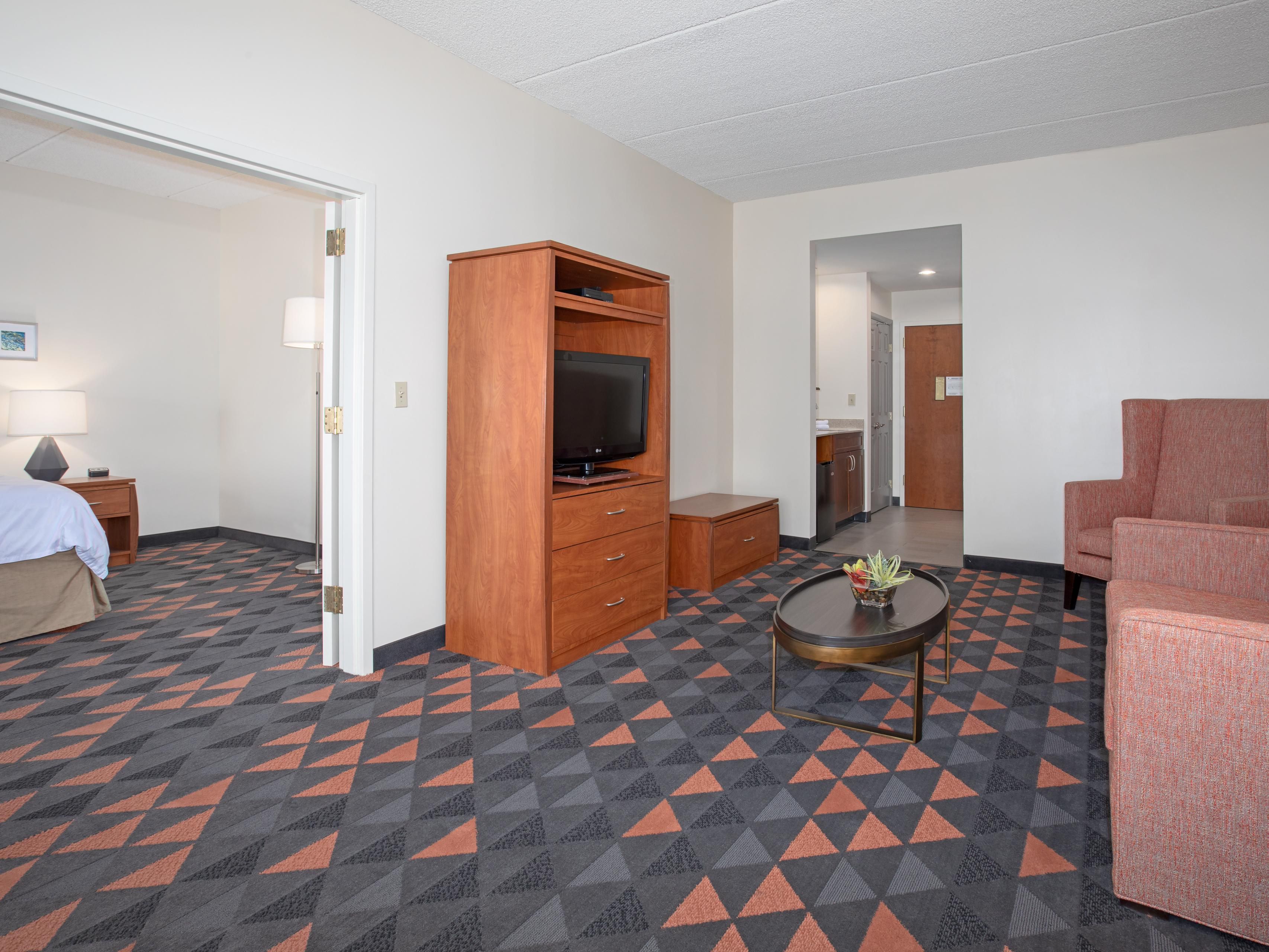 Experience comfort and convenience in our spacious two-room suites, featuring a king bed with crisp triple-sheeting and a separate living room with a sofa sleeper. Each suite offers a microwave, mini fridge, and Keurig, plus a hot tub. Stay productive at a work desk, connected with free Wi-Fi, and enjoy a home-away-from-home feel.