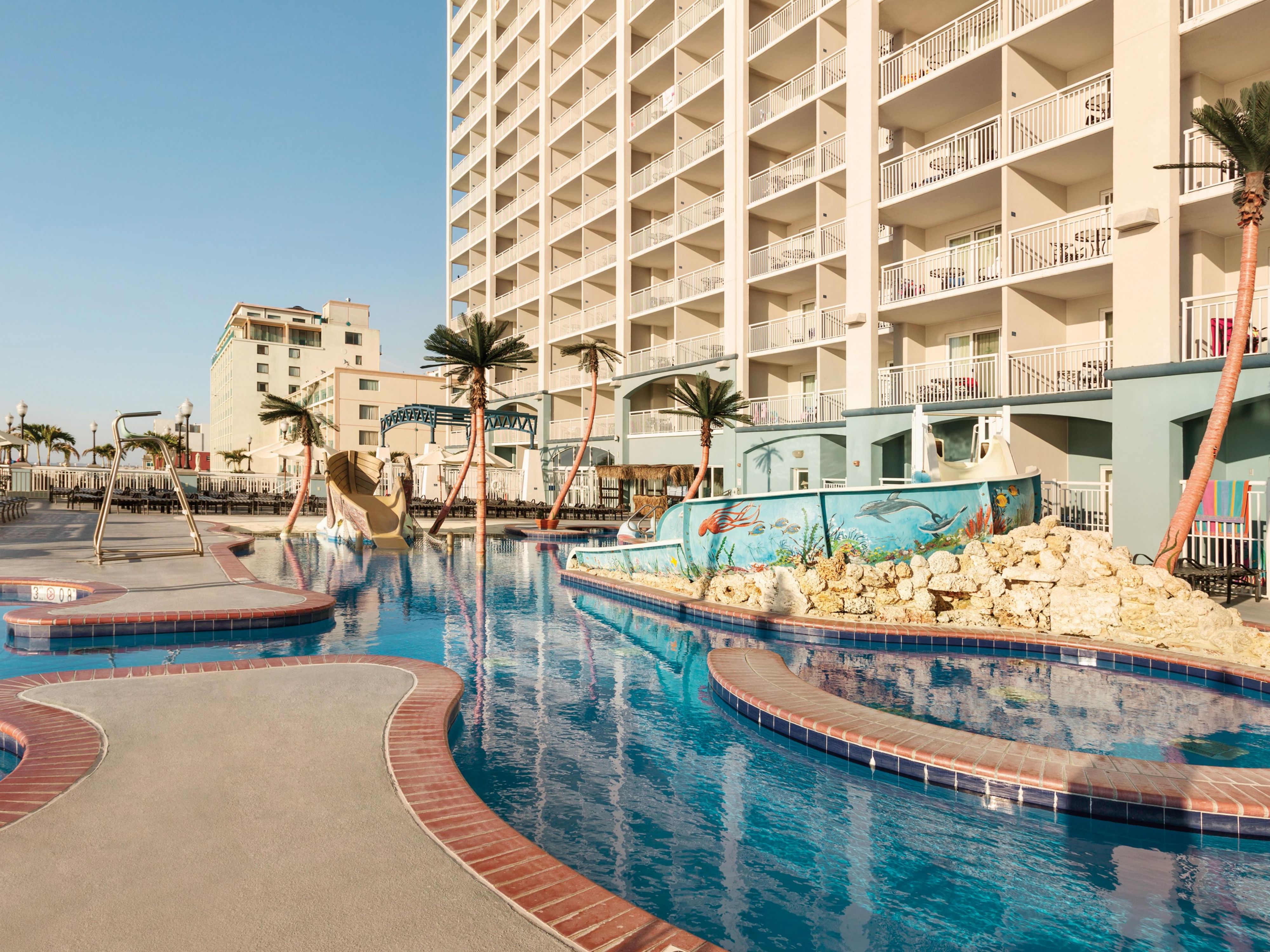 Experience a seamless blend of comfort and luxury at our recently renovated full-suite hotel on the Ocean City Boardwalk with modern amenities like a private balcony or patio, full kitchen, separate bedrooms, hot tubs, and two oceanfront outdoor pools with a pool bar.
