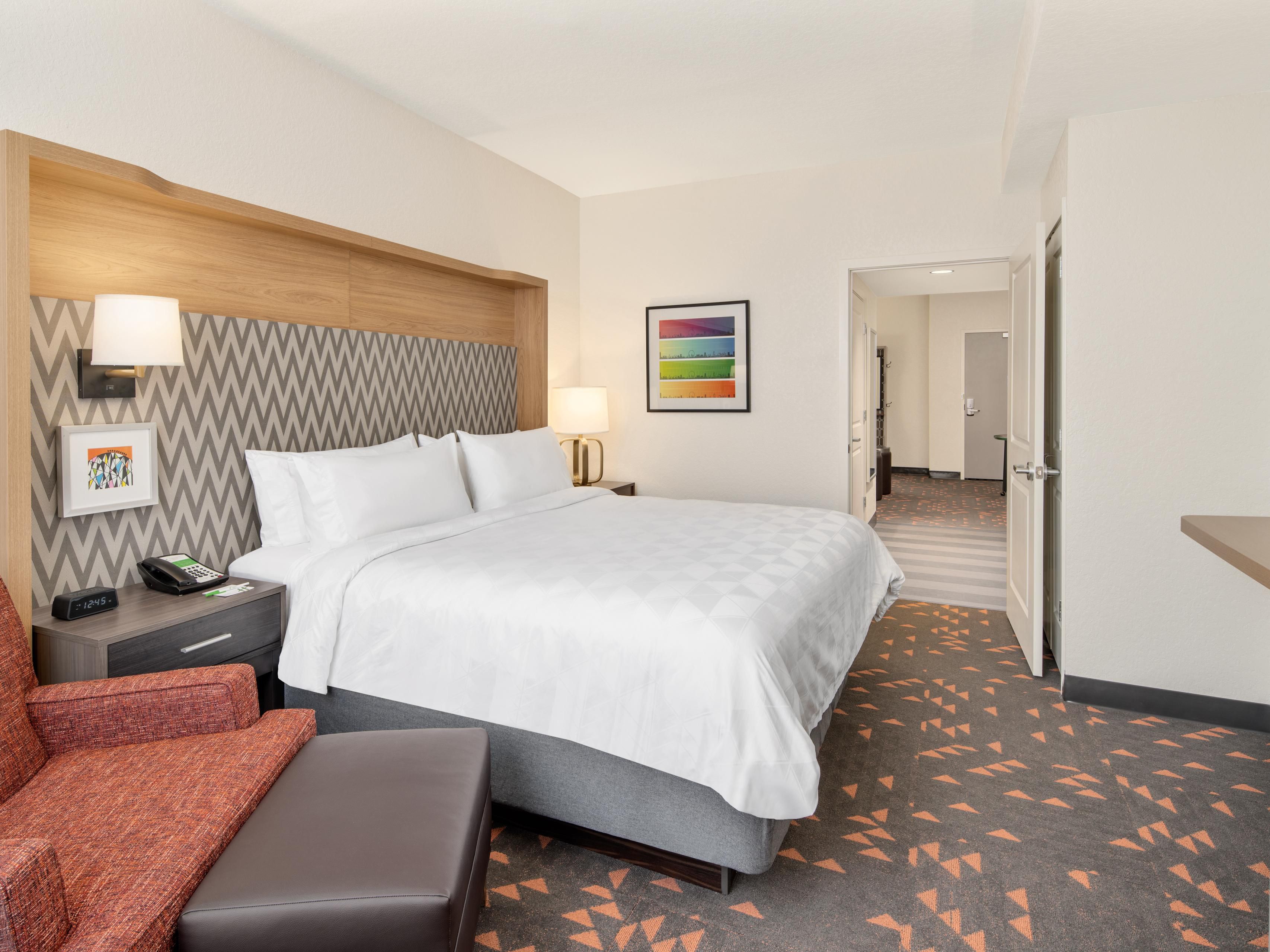 King suite with armchair at Holiday Inn & Suites Orlando I-Drive.