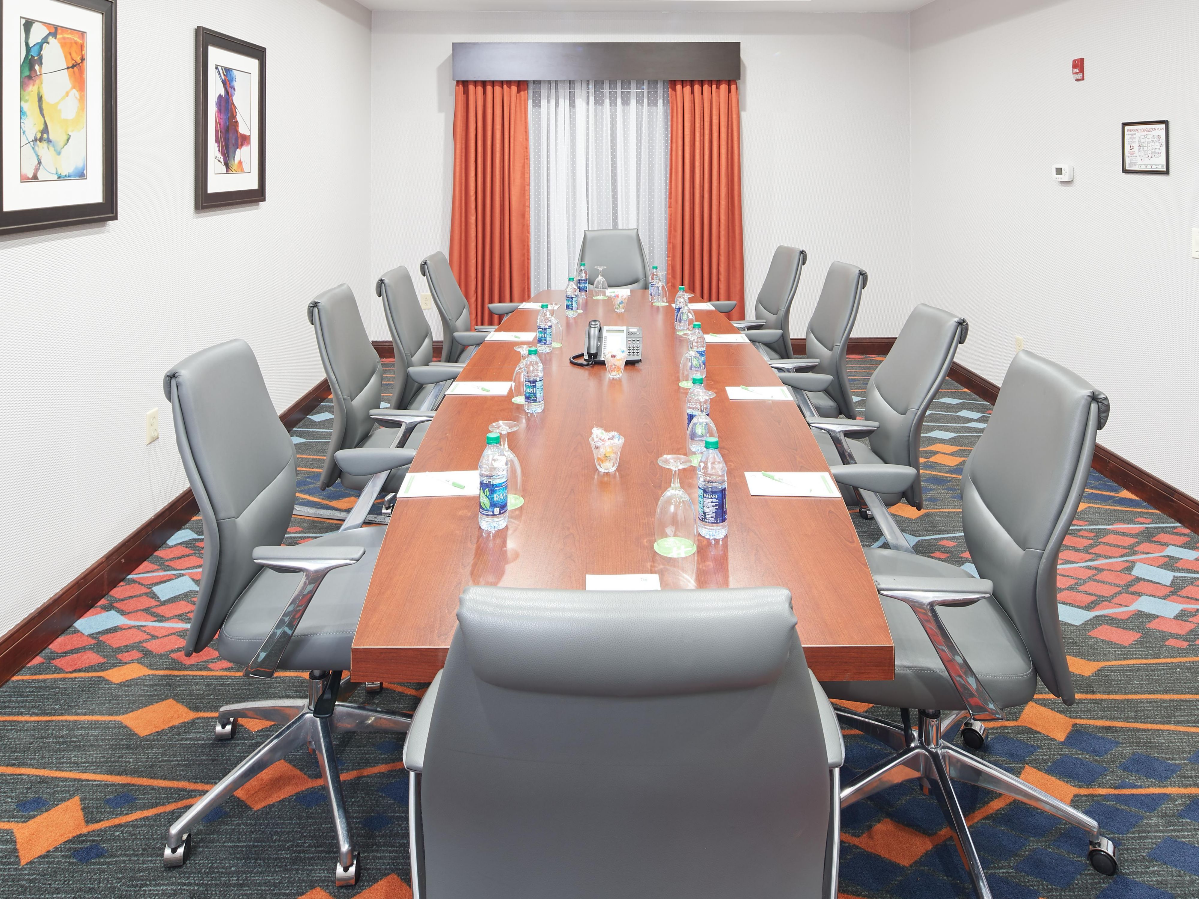 Comfortable conference room accommodates up to 12 clients. Perfect for business meetings and small gatherings. Providing a large business table and comfortable office chairs, LCD projector and screen, 50 inch television, flip chart and easel. 