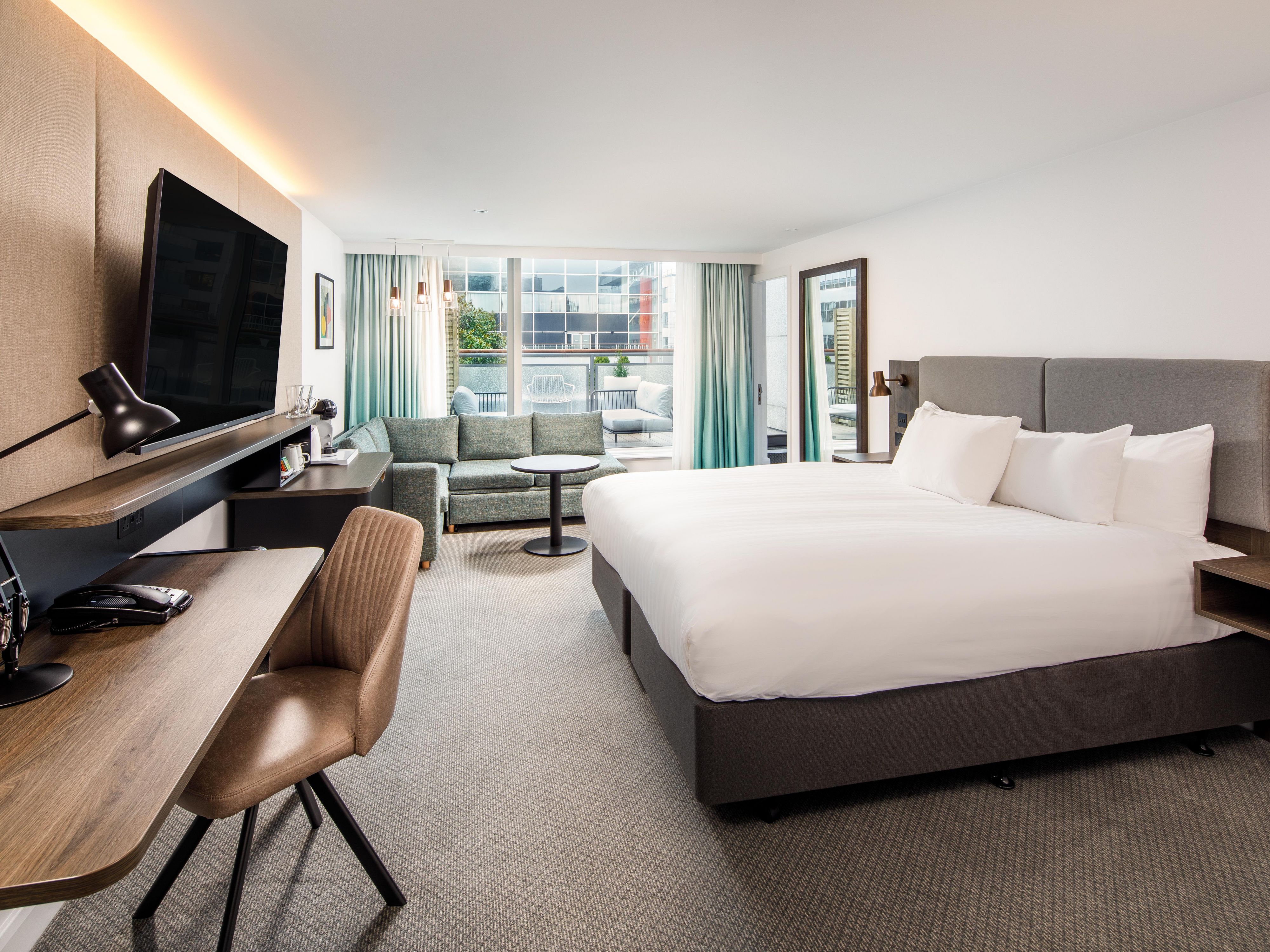 A modern, super king bedroom with outdoor balocny.