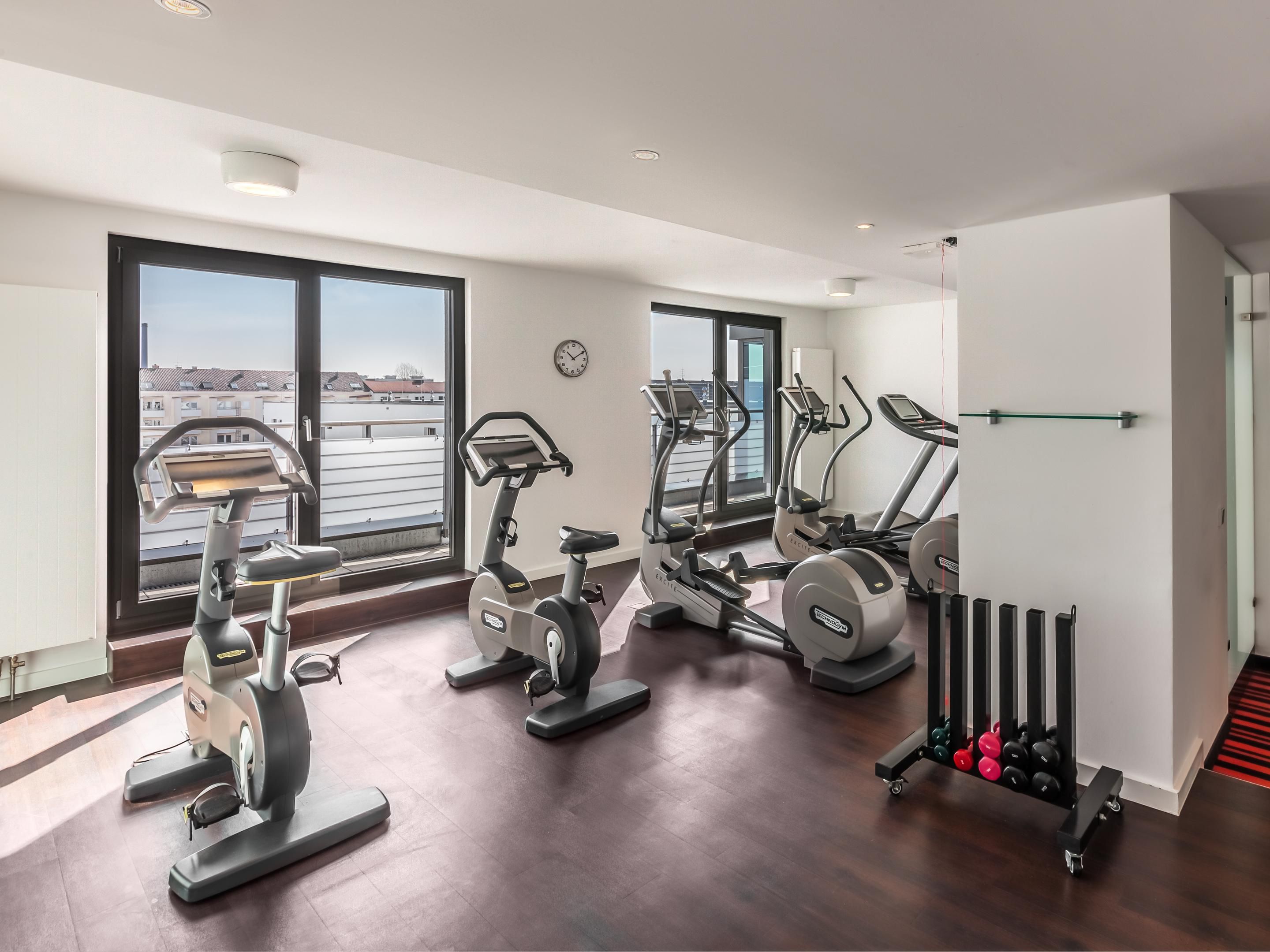 An on-site fitness room offering cardio machines and weights.