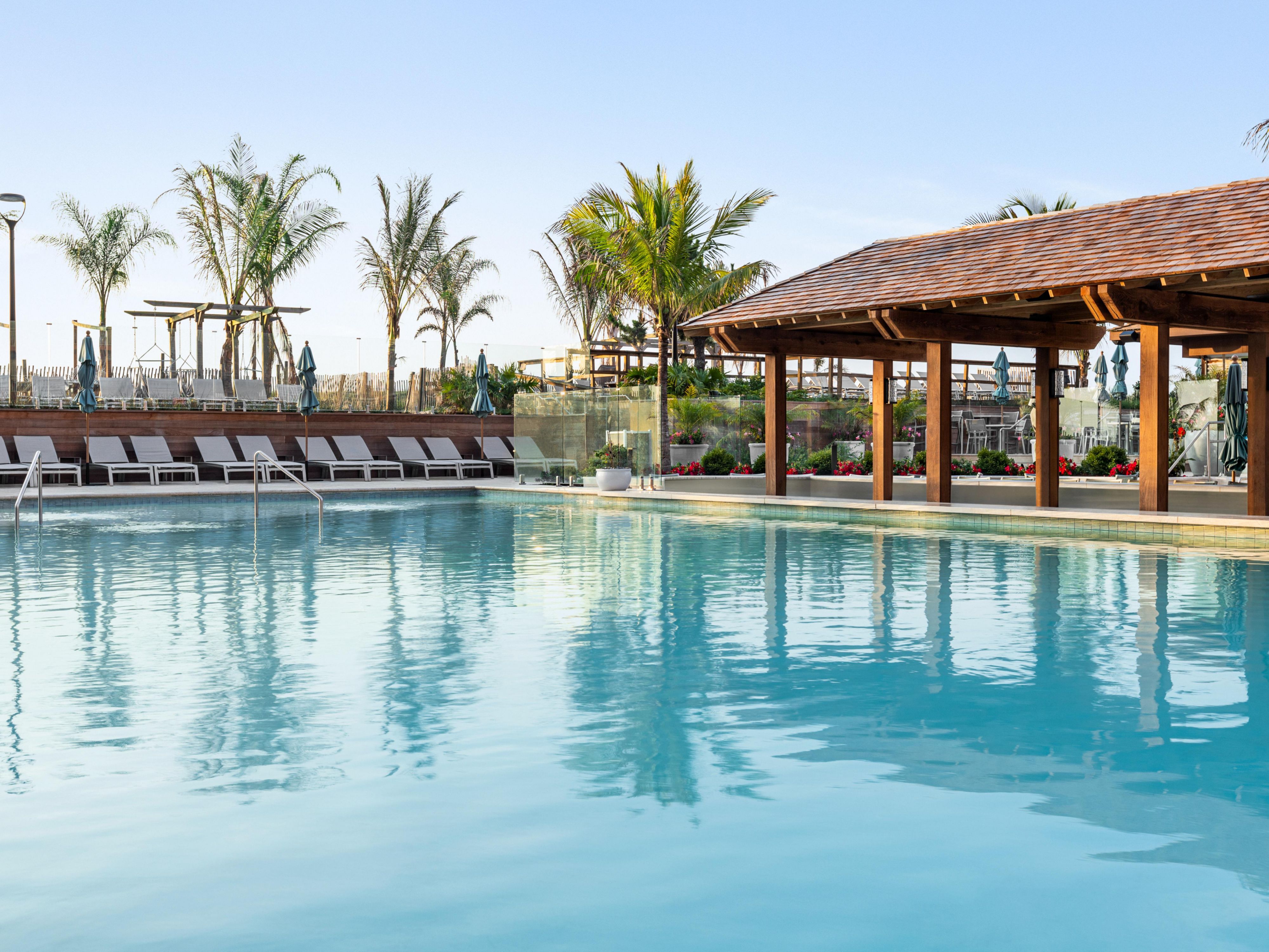 Our outdoor area features a pool with a swim-up bar, a soothing hot tub, and cozy fire pits, creating an outdoor oasis perfect for relaxation and recreation. Enjoy a refreshing dip, sip on your favorite drink, and unwind by the fire for an unforgettable experience.