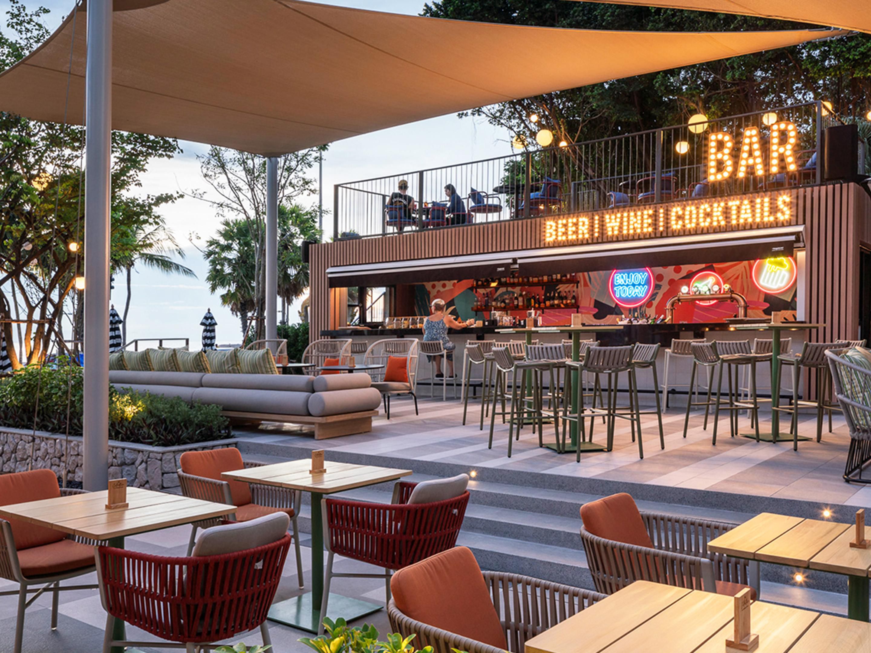 Experience Pattaya's premier dining destination featuring authentic wood-fired Italian pizzas, 12-hour smoked BBQ meats, fresh Thai seafood, and premium Guss Damn Good ice cream. Enjoy a refreshing cocktail on our outdoor terrace with live music and stunning beachfront views. Open daily 12pm-12am for an unforgettable culinary journey.