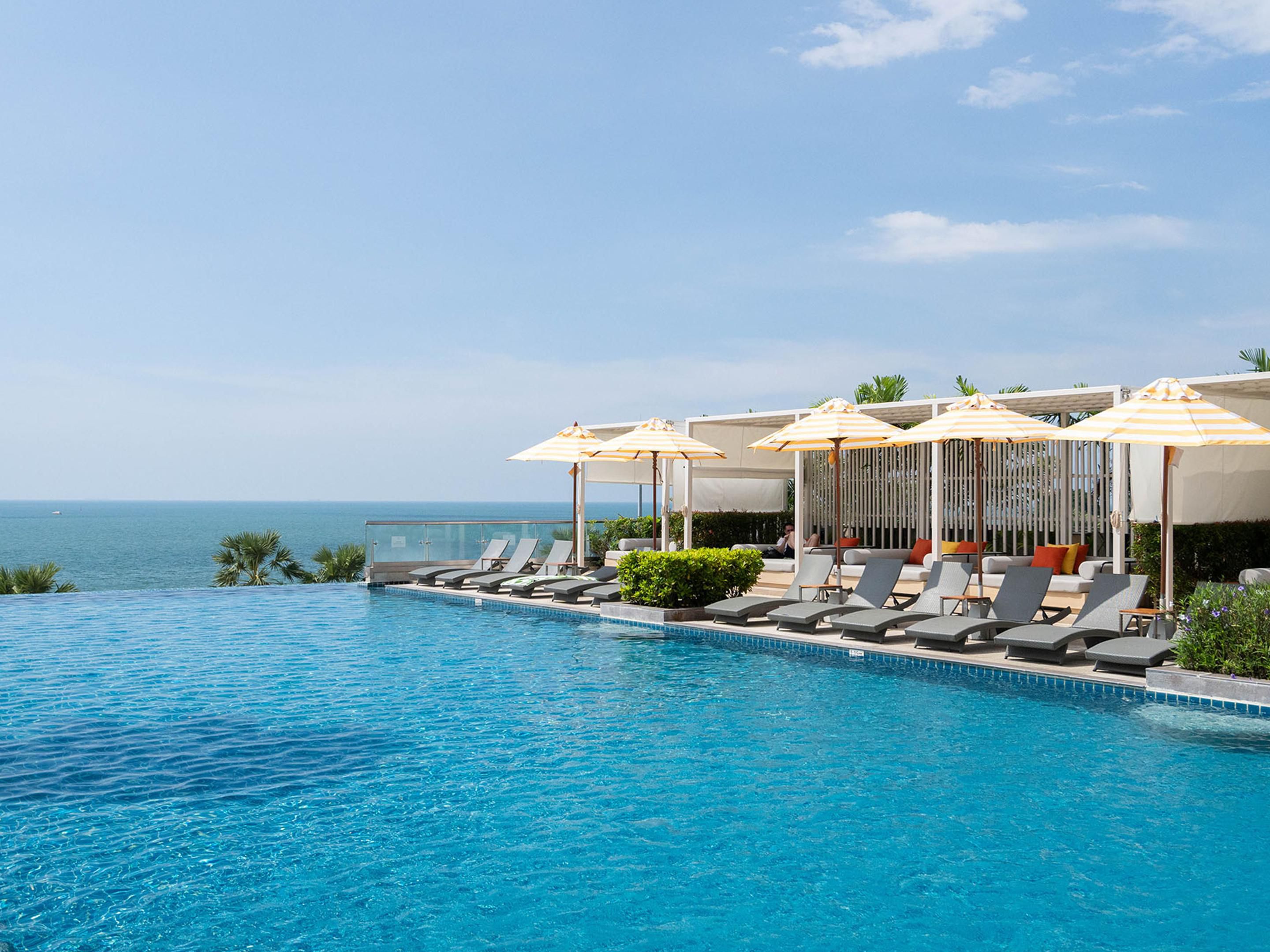 Dive into luxury at our two stunning infinity pools, where crystal-clear waters blend seamlessly with ocean horizons. Our main infinity pool offers tranquil relaxation with panoramic Pattaya Bay views, while the family pool features exciting water play areas perfect for children. Poolside service delivers tropical refreshments right to your lounger