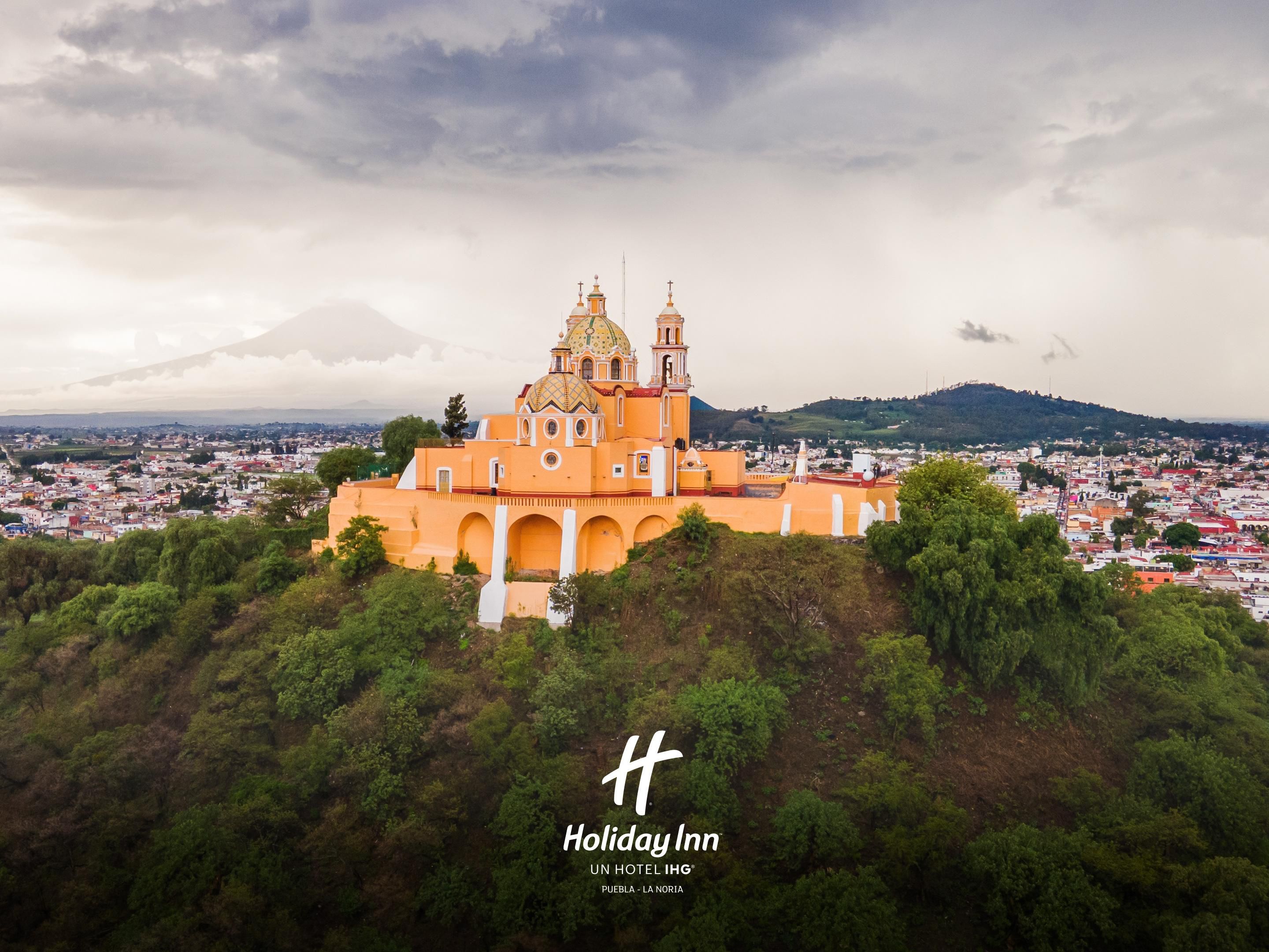 Discover Cholula, the "city of two towns," San Pedro and San Andrés, guarded by the majestic Popocatépetl. Visit the Sanctuary of Our Lady of Remedies, featuring tile-covered domes that rise above the Great Pyramid. Come and enjoy this treasure and one of the one day trips in Puebla!