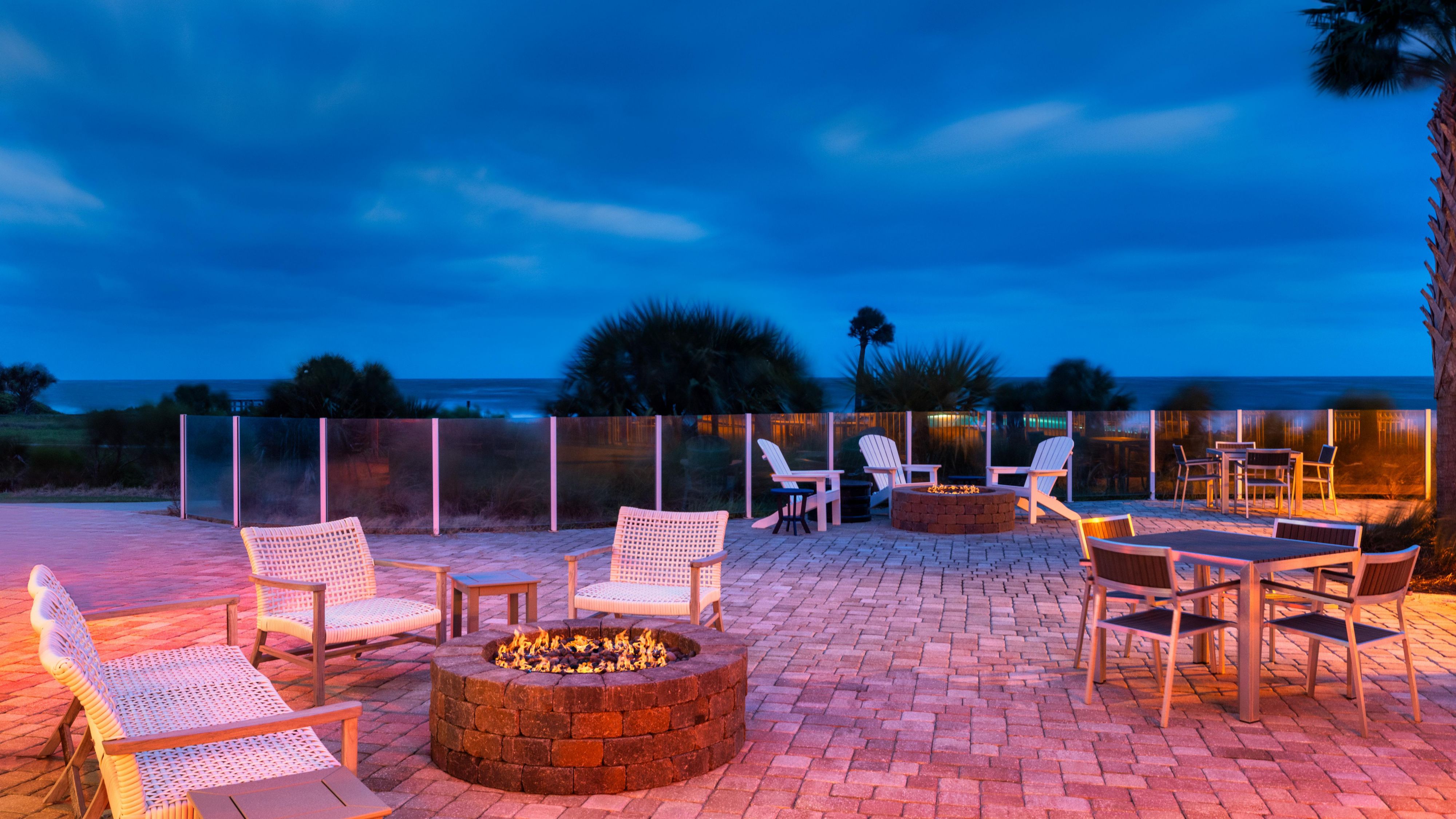 Courtyard in the evening with a firepit and ocean view