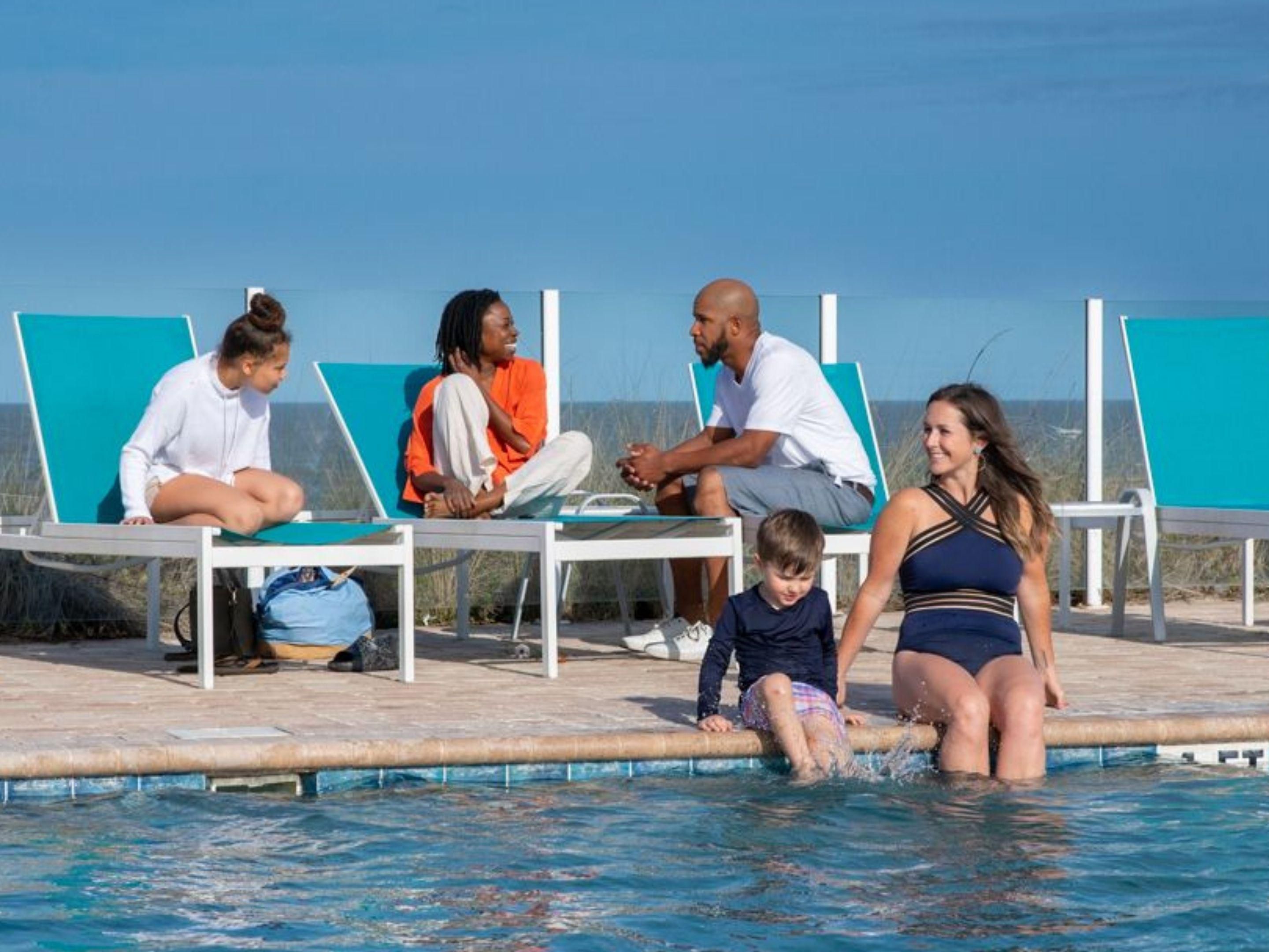 Family sitting around the pool