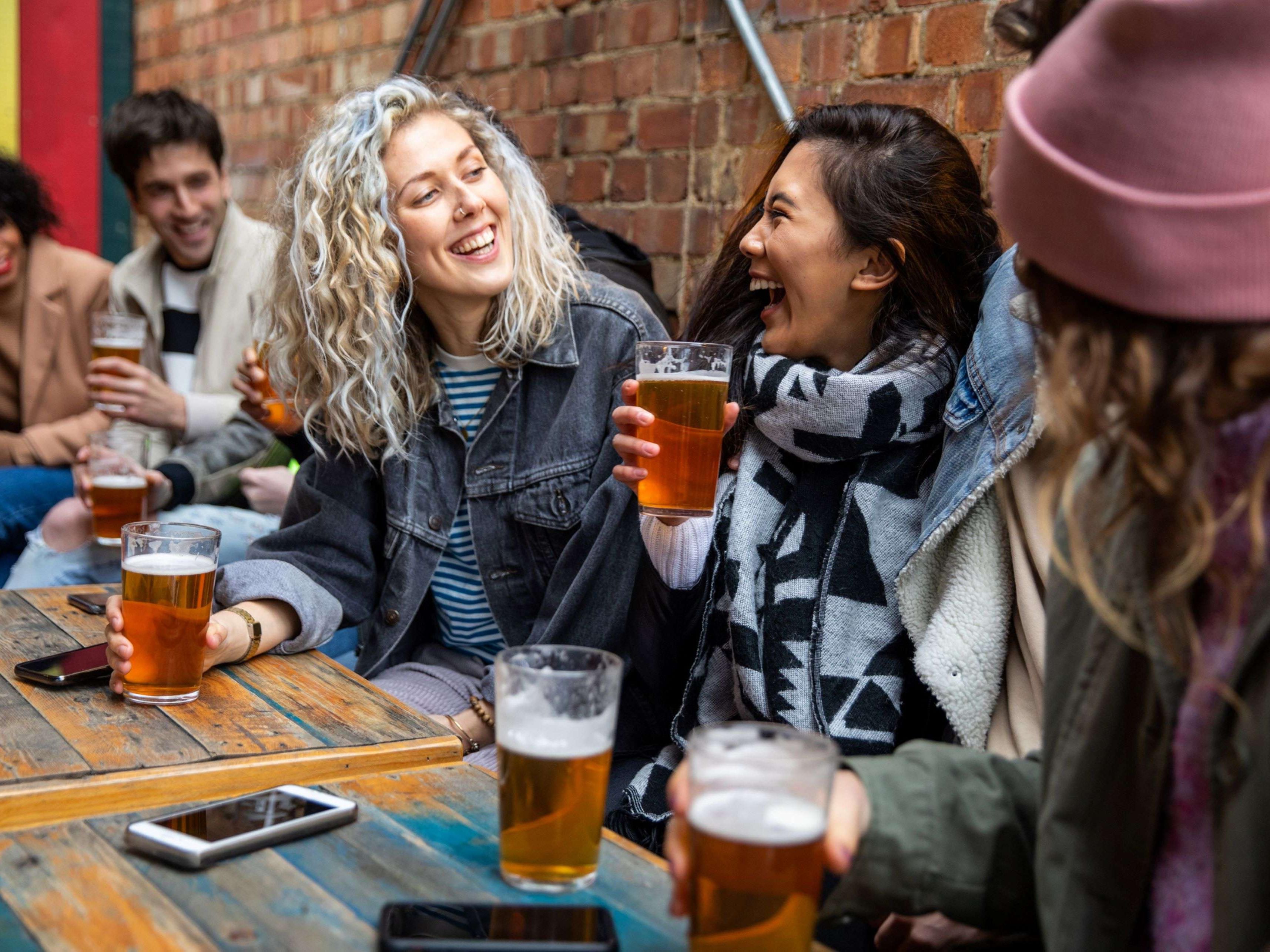 Group of people laughing over beer