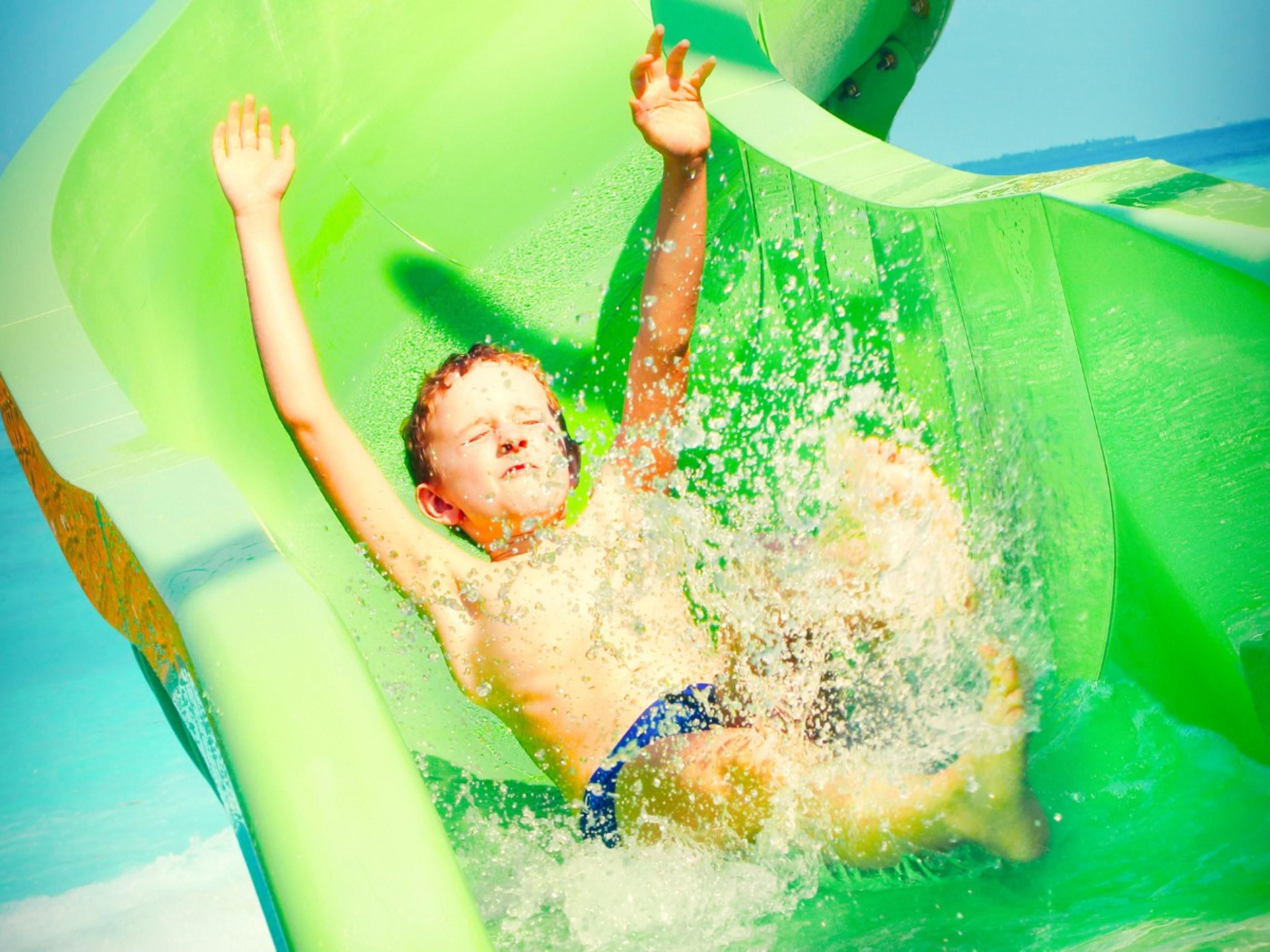 Boy sliding down water slide