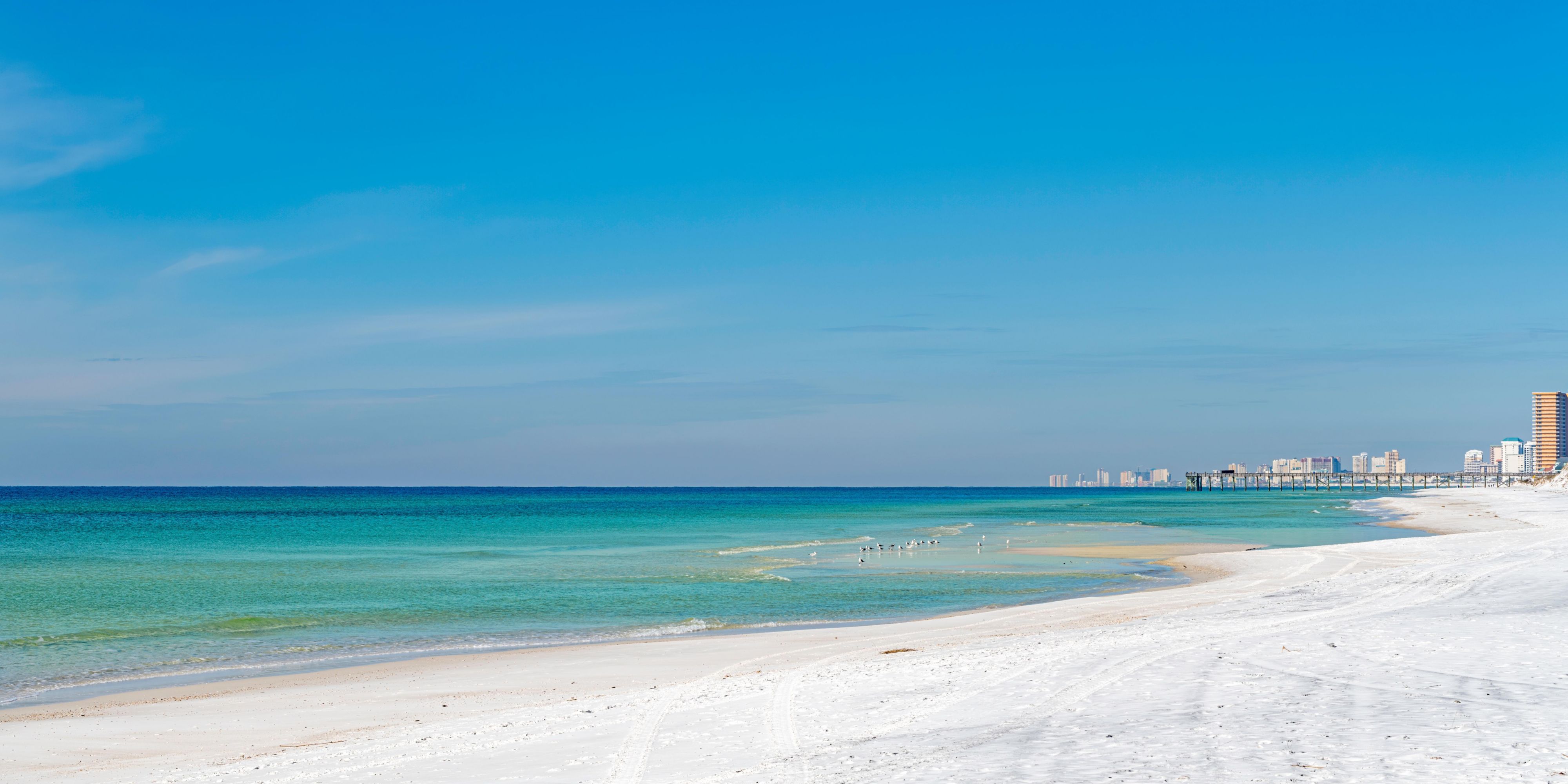 Stroll the beautiful white sand beach just outside our hotel doors